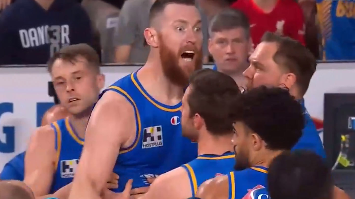 Aron Baynes had to be held back by his teammates after the fiery clash