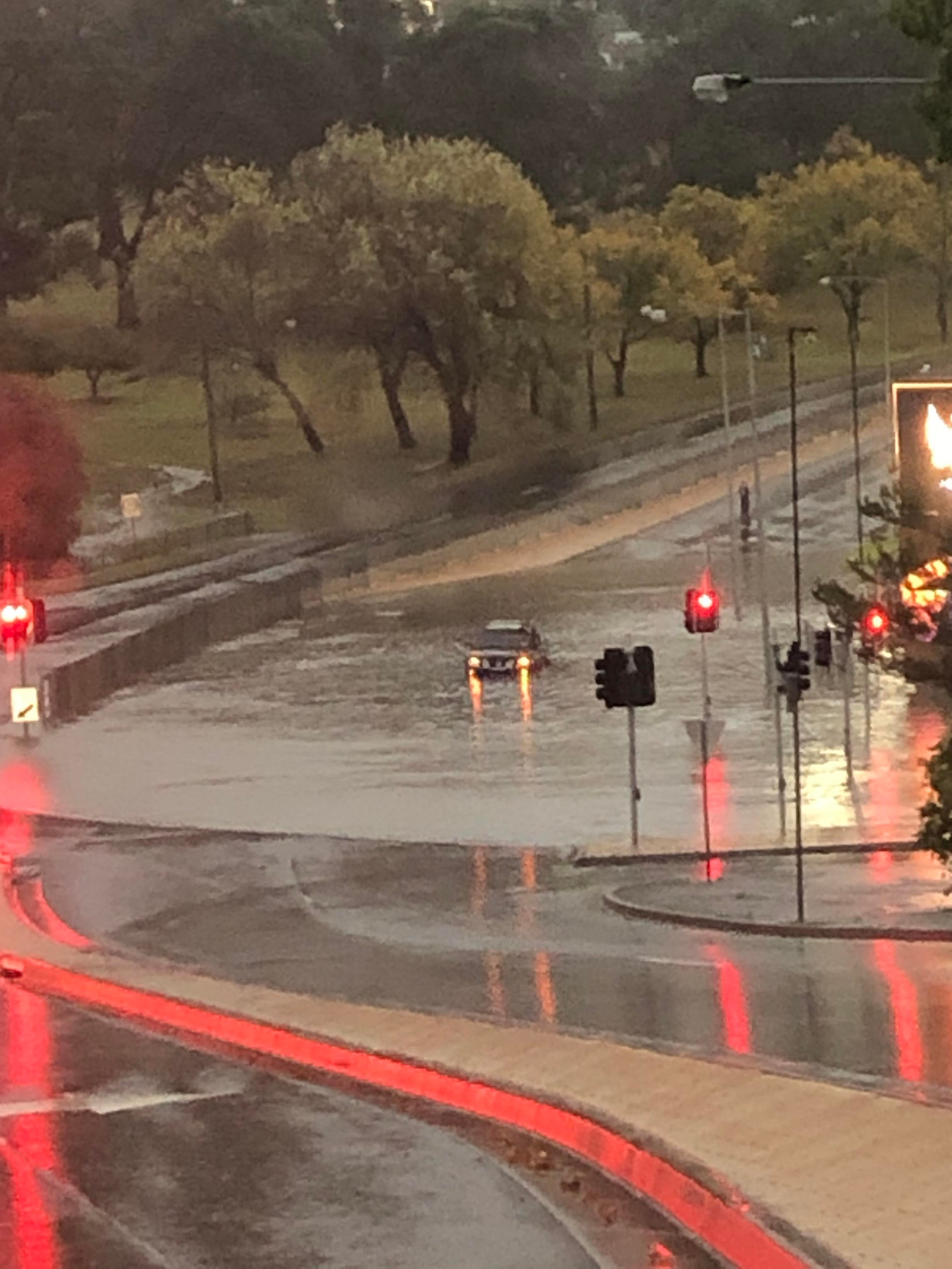 Local Amanda Langer came across a car stuck in floodwaters at the Eastland Intersection in Hobart.