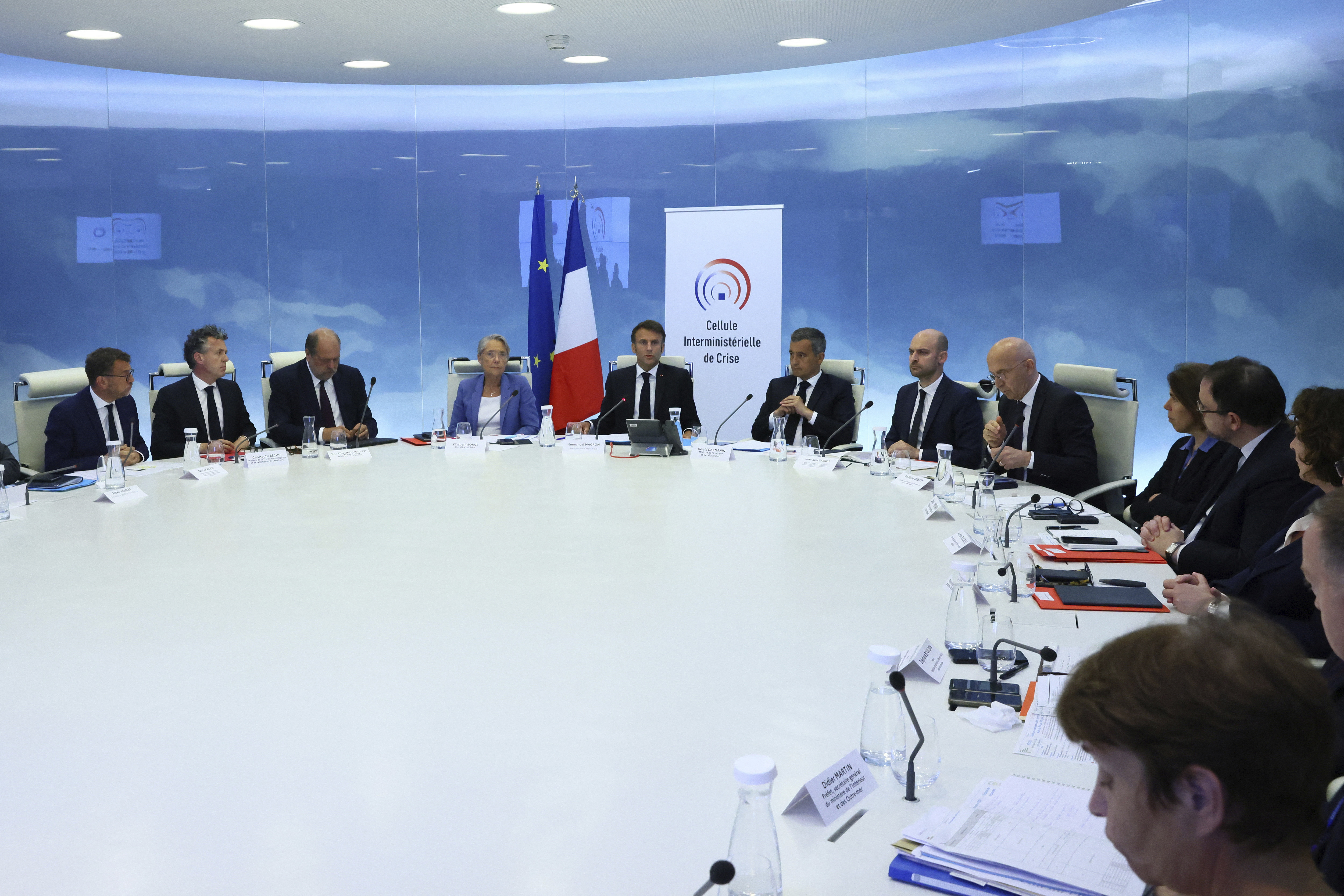 French President Emmanuel Macron, centre, chairs a government emergency meeting after riots erupted for the third night in a row across the country, at the Interior Ministry in Paris, Friday, June 30, 2023.  