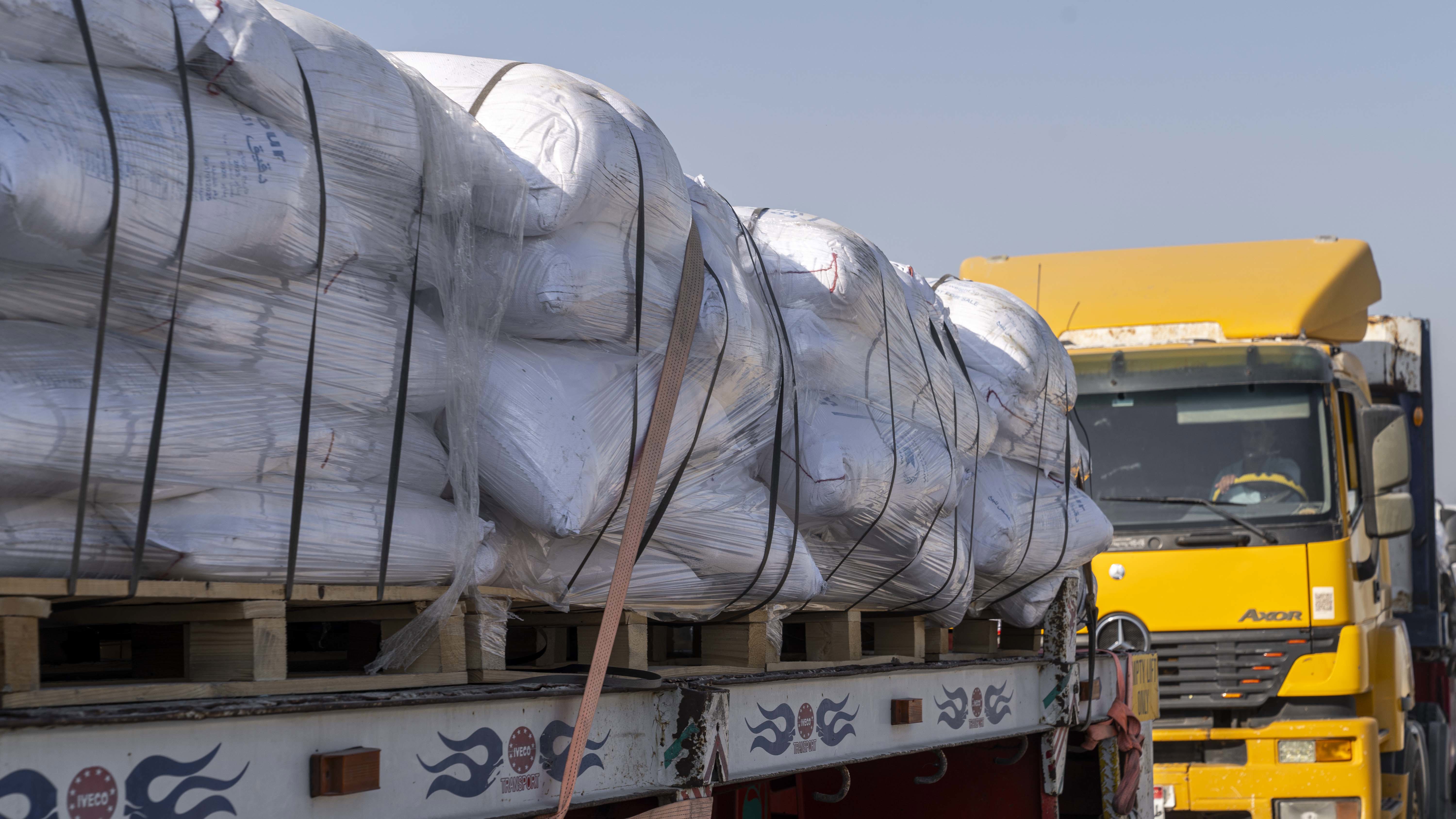 Trucks carrying aid enter Gaza through the Rafah border crossing in Rafah, Egypt. Israel announce a "tactical pause" in fighting in some parts of Gaza, including near the Rafah crossing.