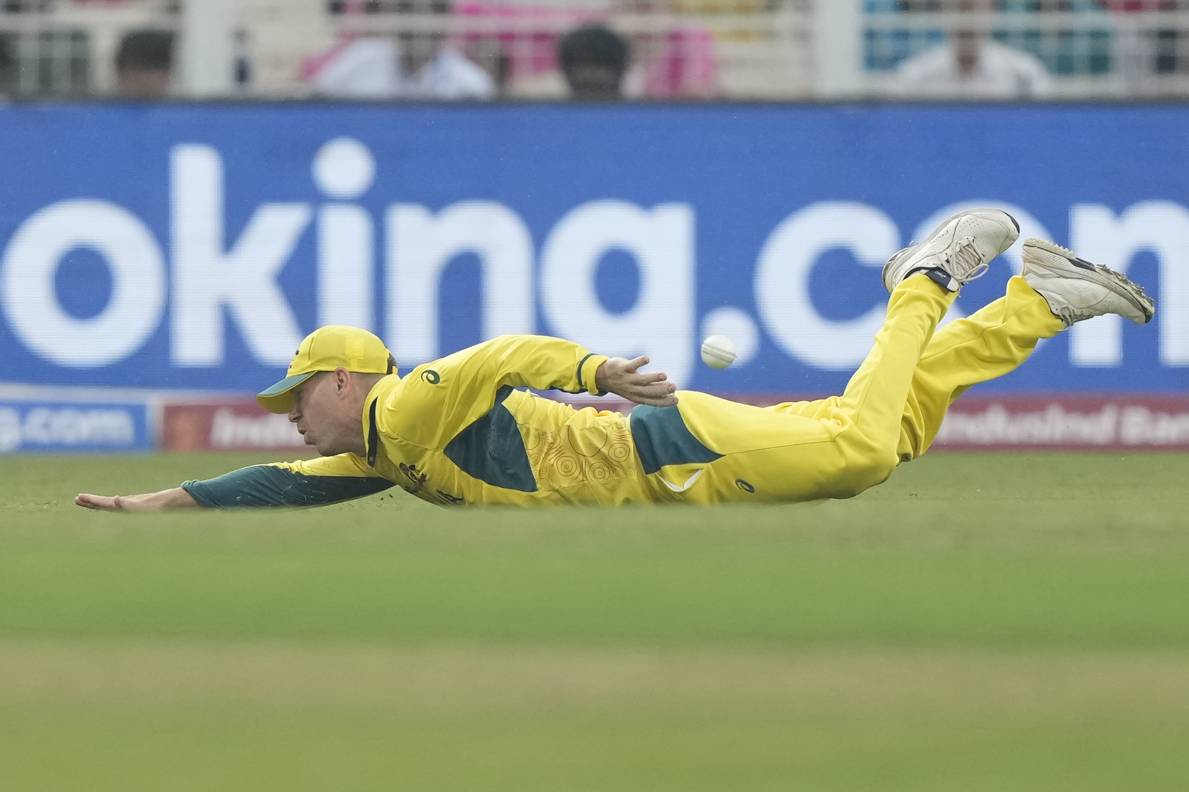 Australia's David Warner fields a ball during the ICC Men's Cricket World Cup second semifinal match between Australia and South Africa in Kolkata, India, Thursday, Nov. 16, 2023. (AP Photo/Mahesh Kumar A.)