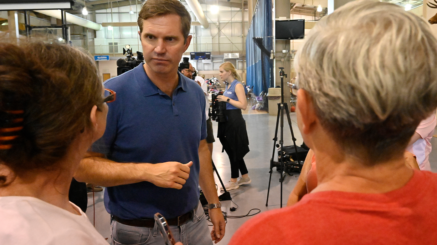 Kentucky Governor Andy Beshear, center, answers question from residents of Knott County Ky., that have been displaced by floodwaters at the Knott County Sportsplex in Leburn, Sunday, July 31, 2022.