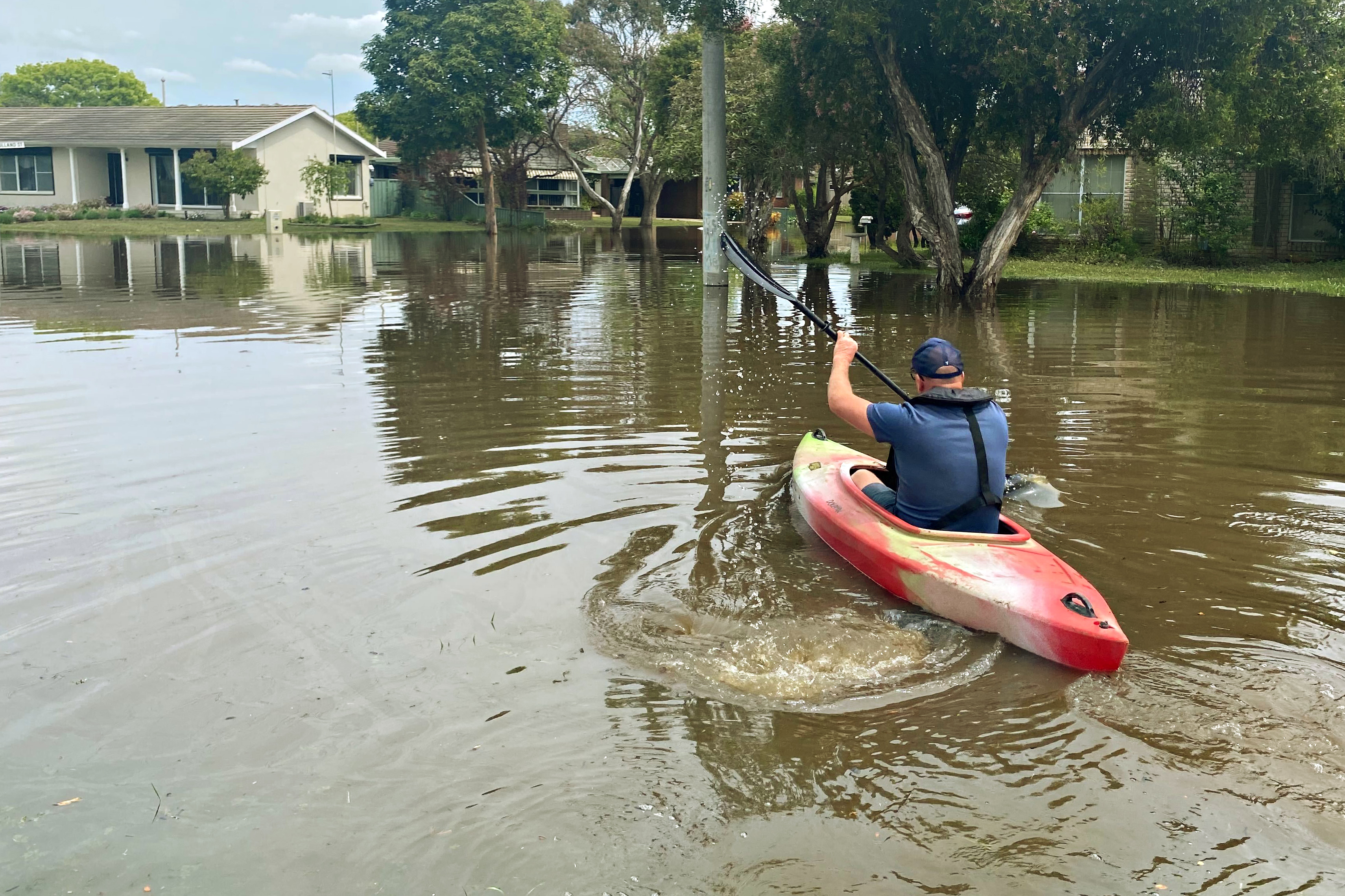 The Age photographer Jason South rows across flood water to get to a community stranded from the rest of Shepparton.