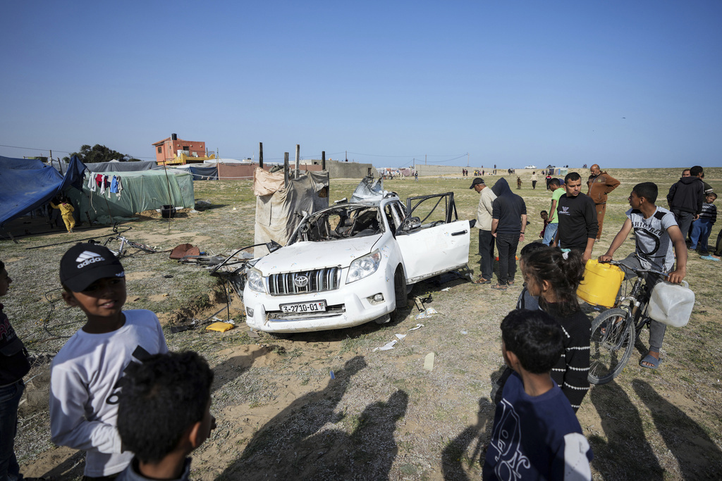 People inspect the site where World Central Kitchen workers were killed in Deir al-Balah, Gaza Strip, Tuesday, April 2, 2024. 