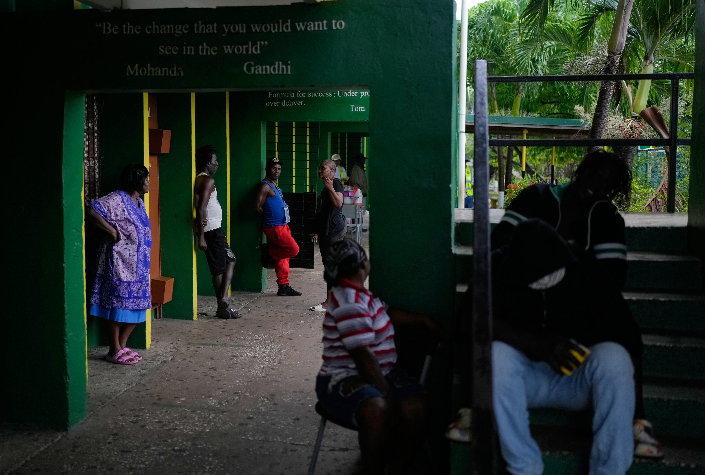 People take shelter at a school ahead of Hurricane Melissa's forecast arrival in Old Harbour, Jamaica, Monday, Oct. 27, 2025. (AP Photo/Matias Delacroix)