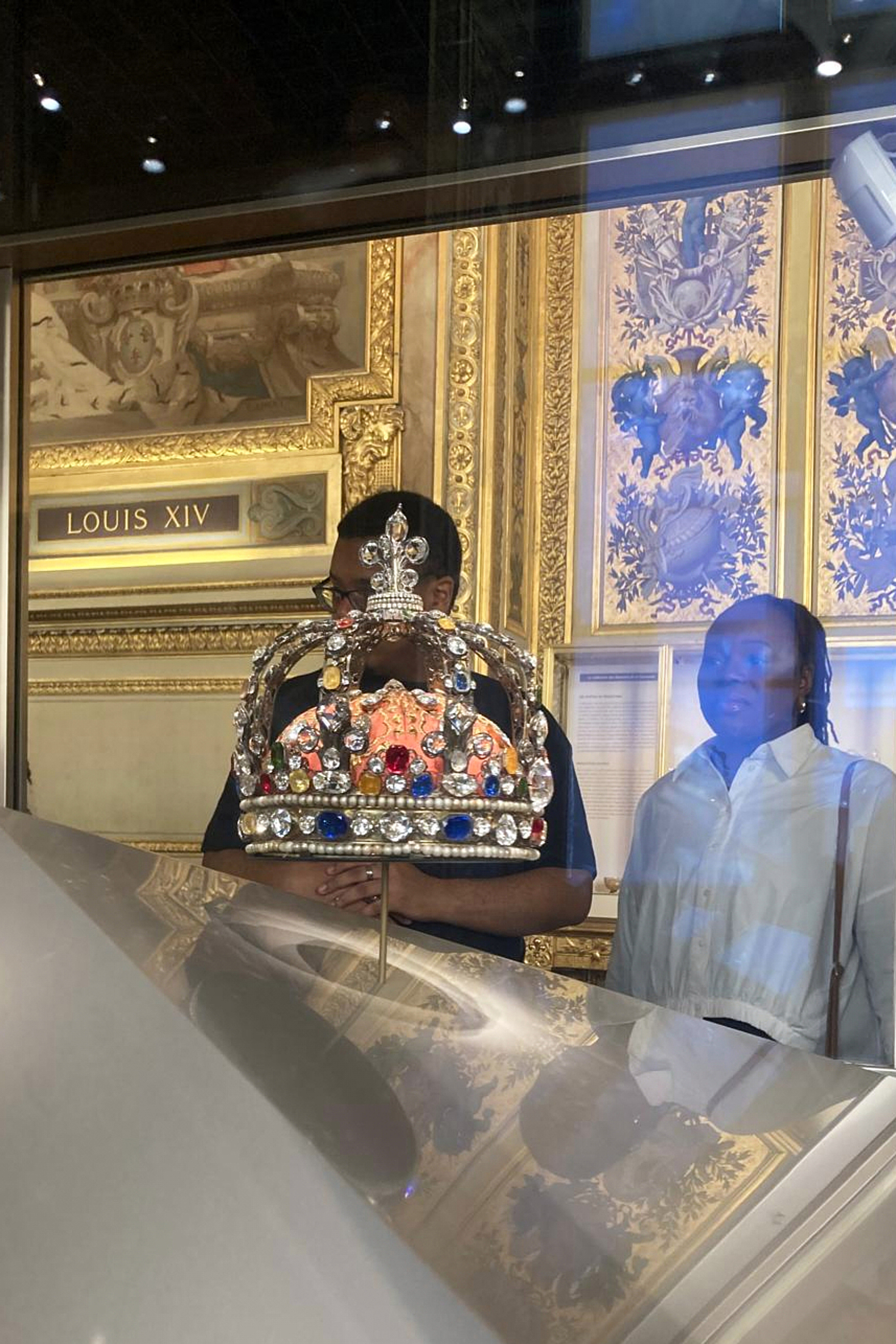 People check jewelry in the Apollo Gallery of the Louvre museum on Sept. 4, 2025 in Paris.