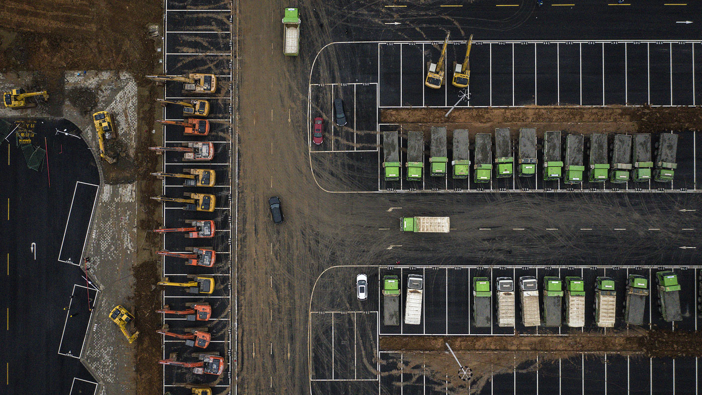 Construction machinery sits at the site of a field hospital on January 26, in Wuhan, Hubei province, China.