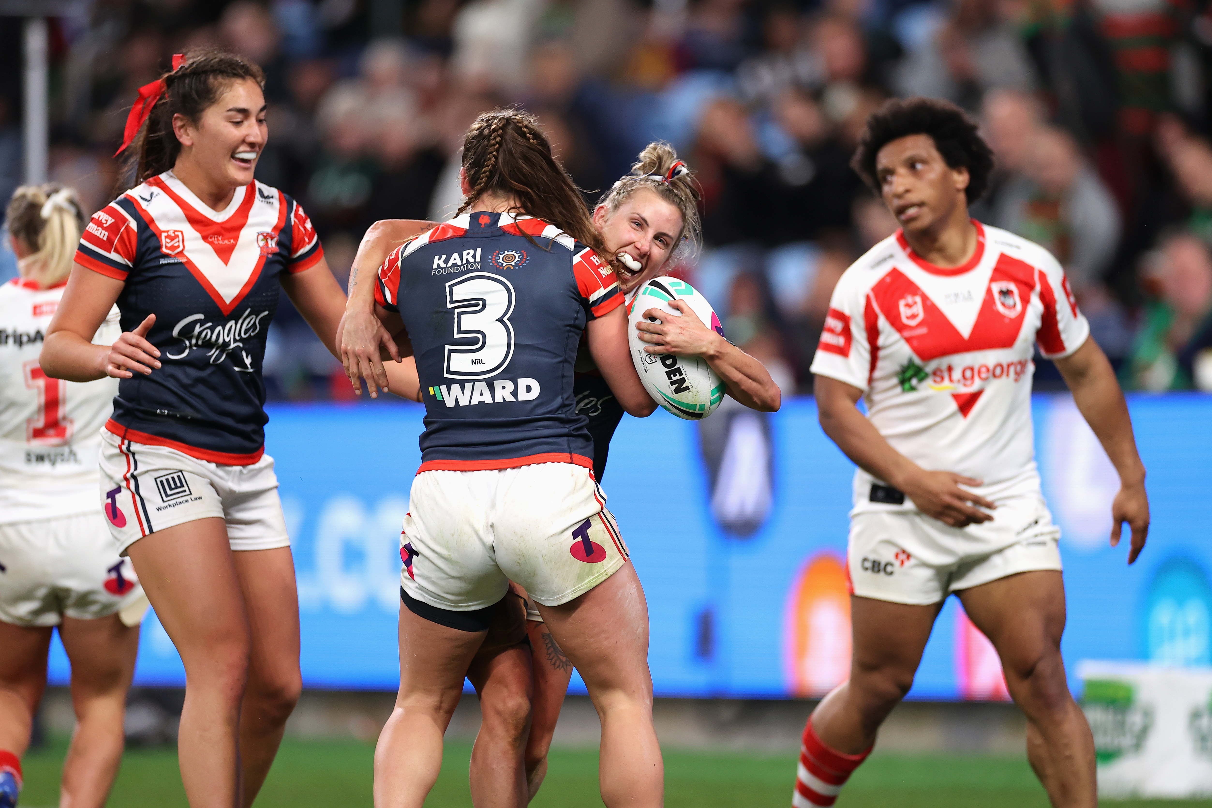 Sam Bremner of the Roosters celebrates scoring a try with Jessica Sergis.
