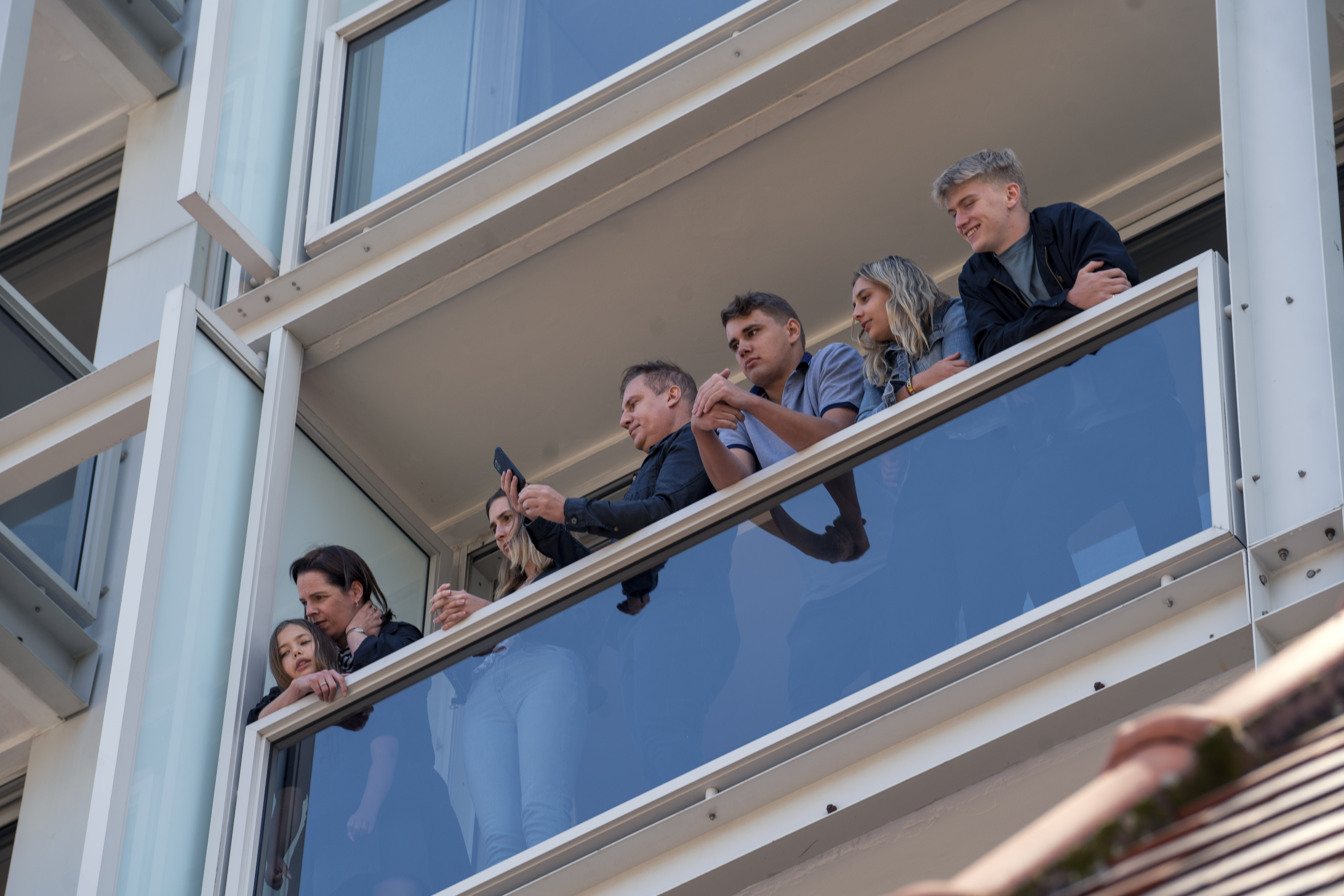 Hotel guests watch the hearse carrying the remains of Anglican Archbishop Emeritus Desmond Tutu leave St. George's Cathedral following his funeral service in Cape Town, South Africa, Saturday, Jan.1, 2022. 