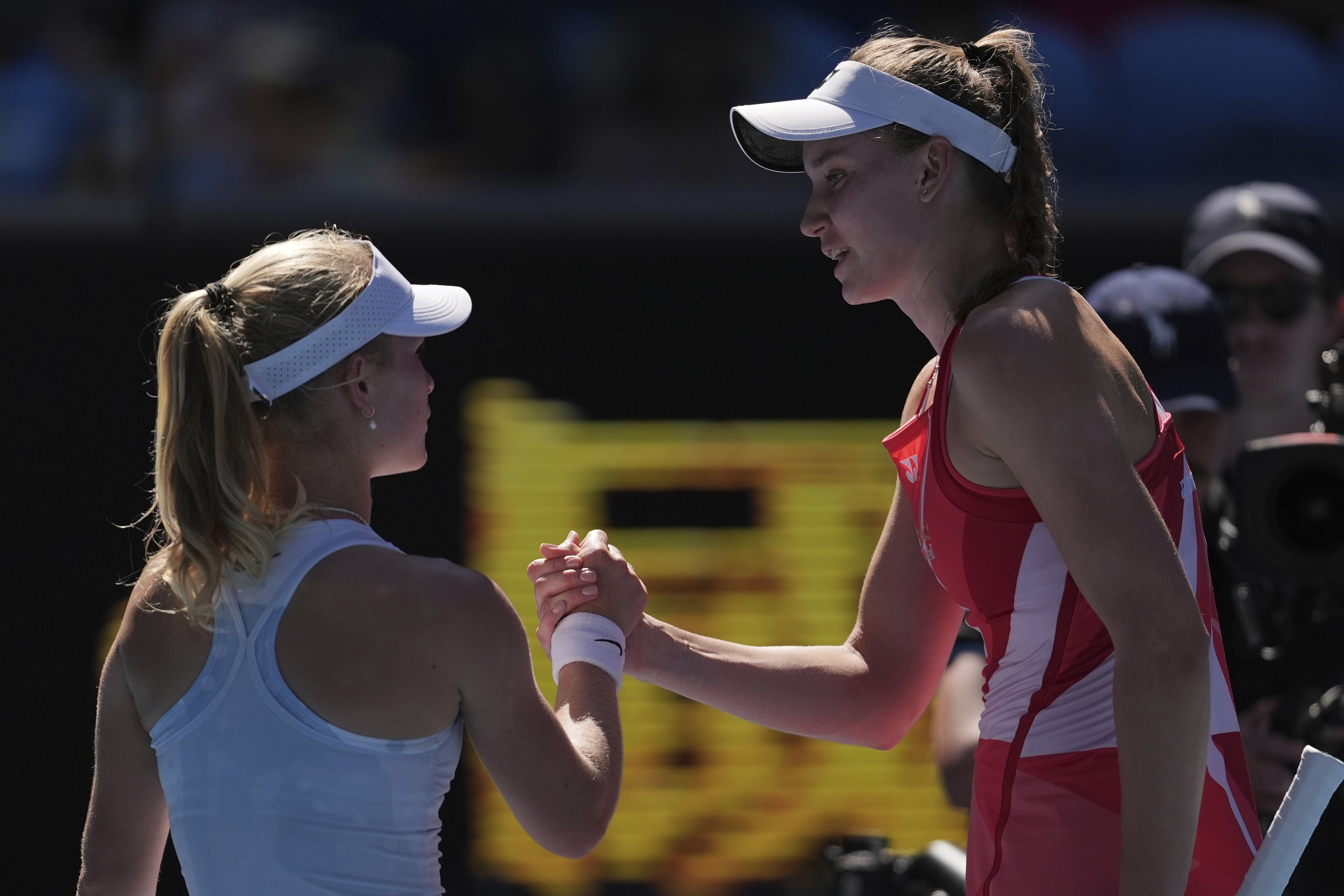 Elena Rybakina, right, of Kazakhstan is congratulated by Emerson Jones of Australia following their first round match at the Australian Open tennis championship in Melbourne, Australia, Tuesday, Jan. 14, 2025. (AP Photo/Ng Han Guan)