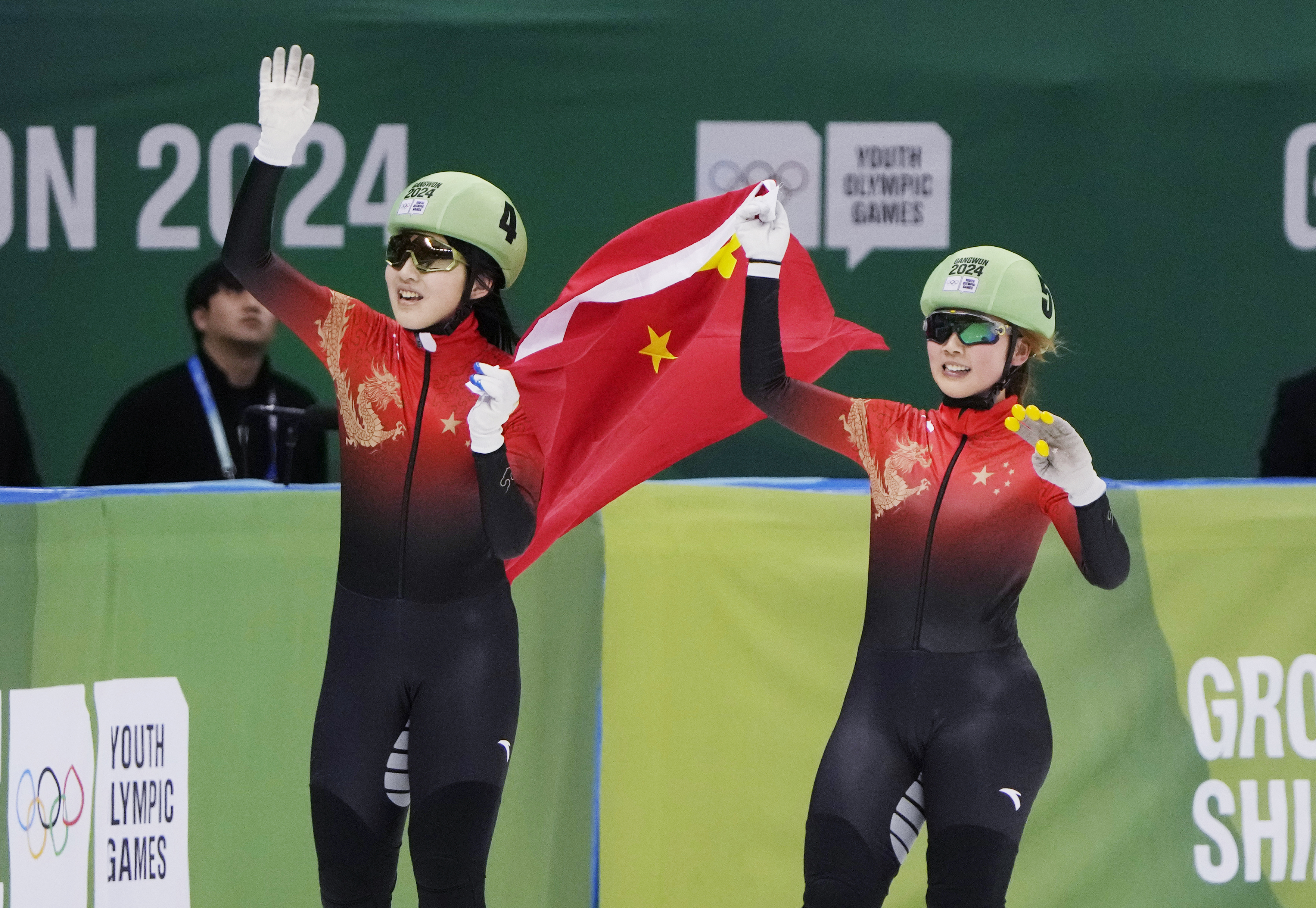 Li Jinzi (left) and Yang Jingru of China celebrate with their national flag in the final of the women's 1000m short track speed skating during the Winter Youth Olympic Games.