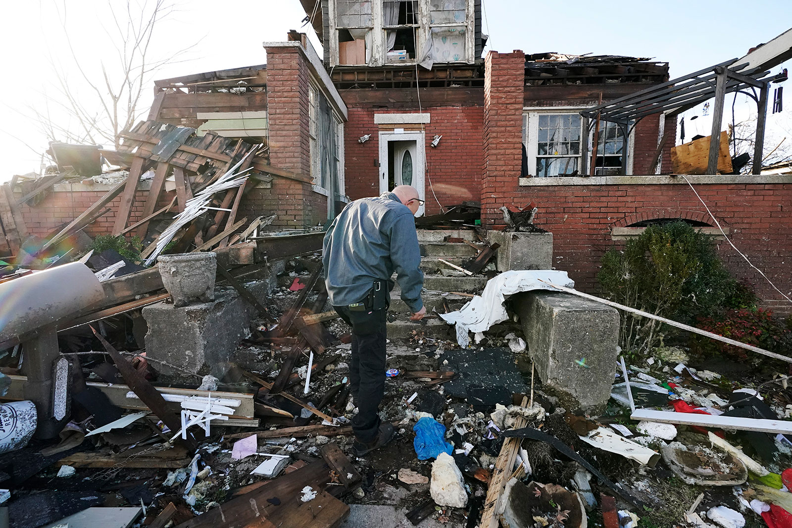 Timothy McDill walks near his tornado-damaged home in Mayfield
