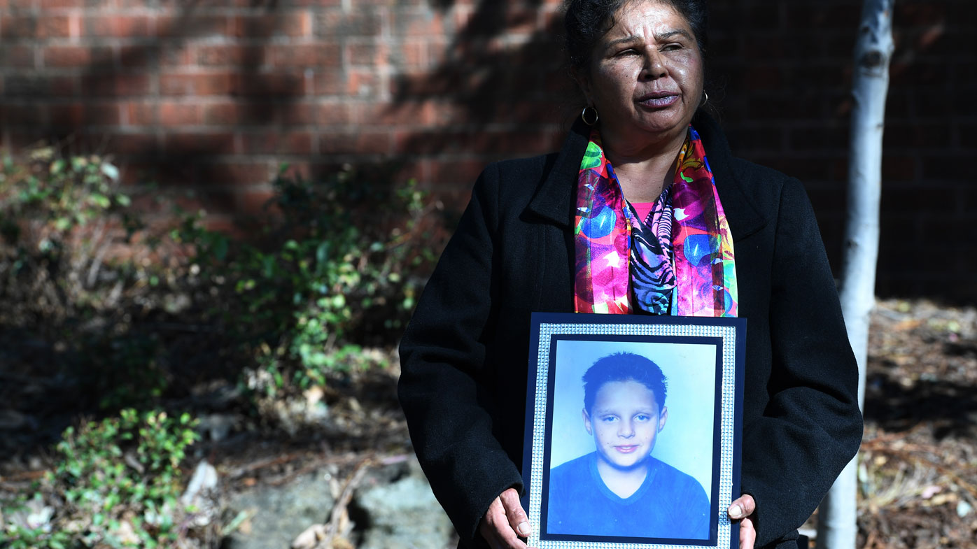 Julie Szabo, the mother of Arthur Haines, who died in a house fire in 1998, holds a picture of her son.