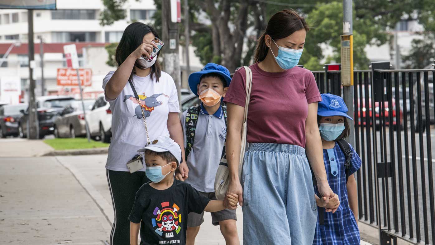 Students and parents wear face masks as they walk to school in Hurstville, in Sydney's south.
