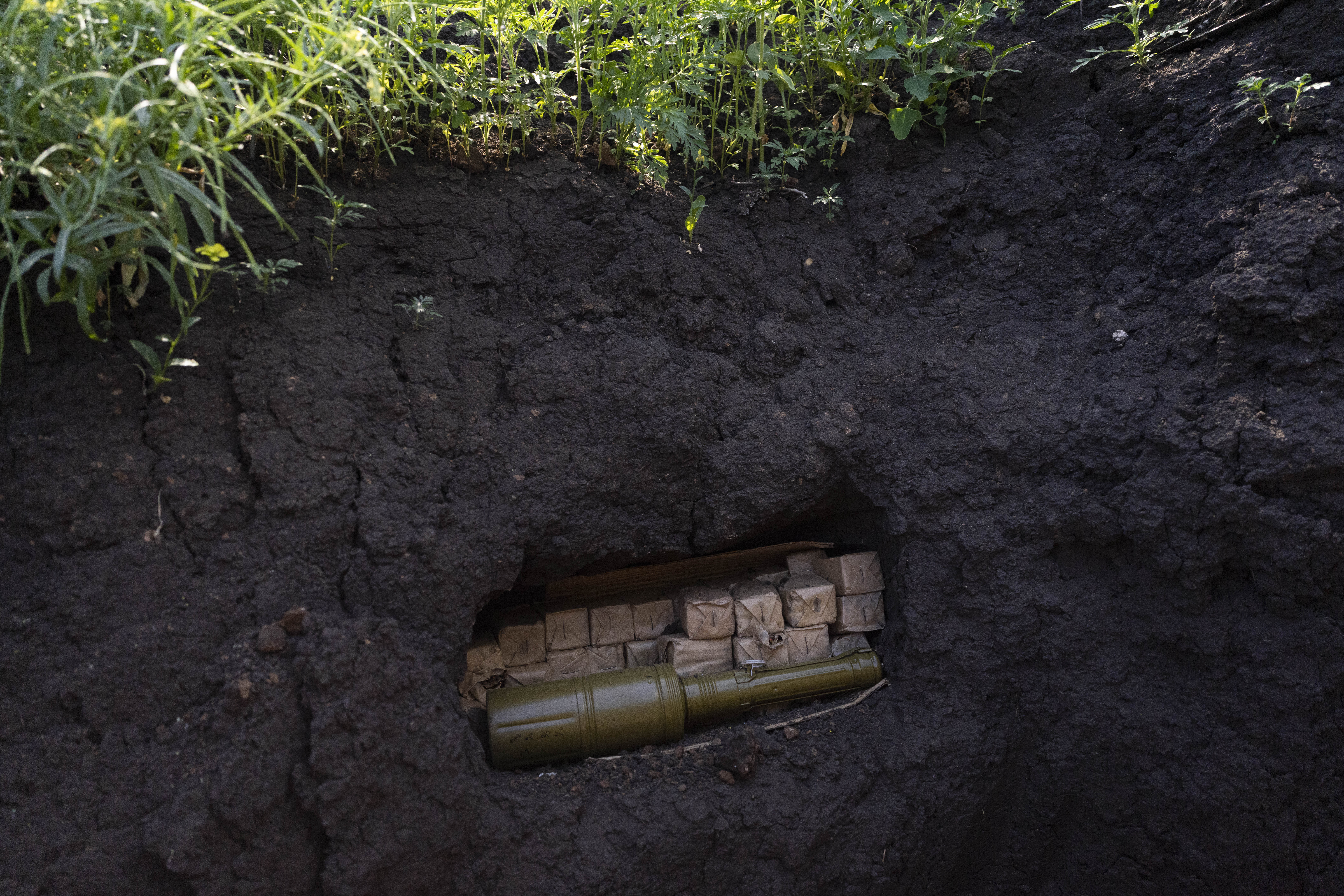 Ammunition is stored in a Ukrainian trench near the frontline in Donetsk region, eastern Ukraine, Wednesday, June 8, 2022. (AP Photo/Bernat Armangue)