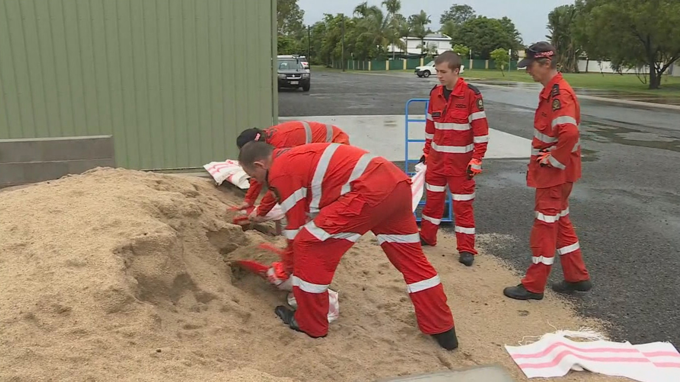 Workers prepare to combat inevitable flooding with sandbags.