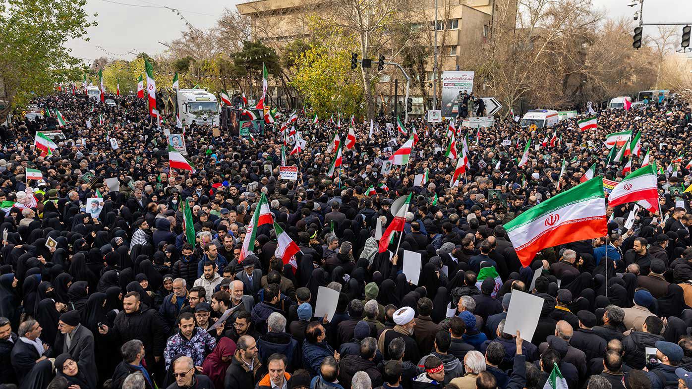 Pro-regime Iranians turn out for a funeral procession for security forces killed by protesters.