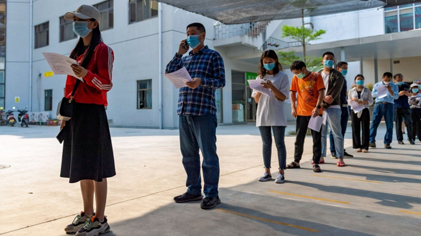 n this photo released by Xinhua News Agency, residents wearing masks line up for COVID-19 vaccination at the Jingcheng Hospital in Ruili city in southwestern China's Yunnan Province, April 1, 2021. 