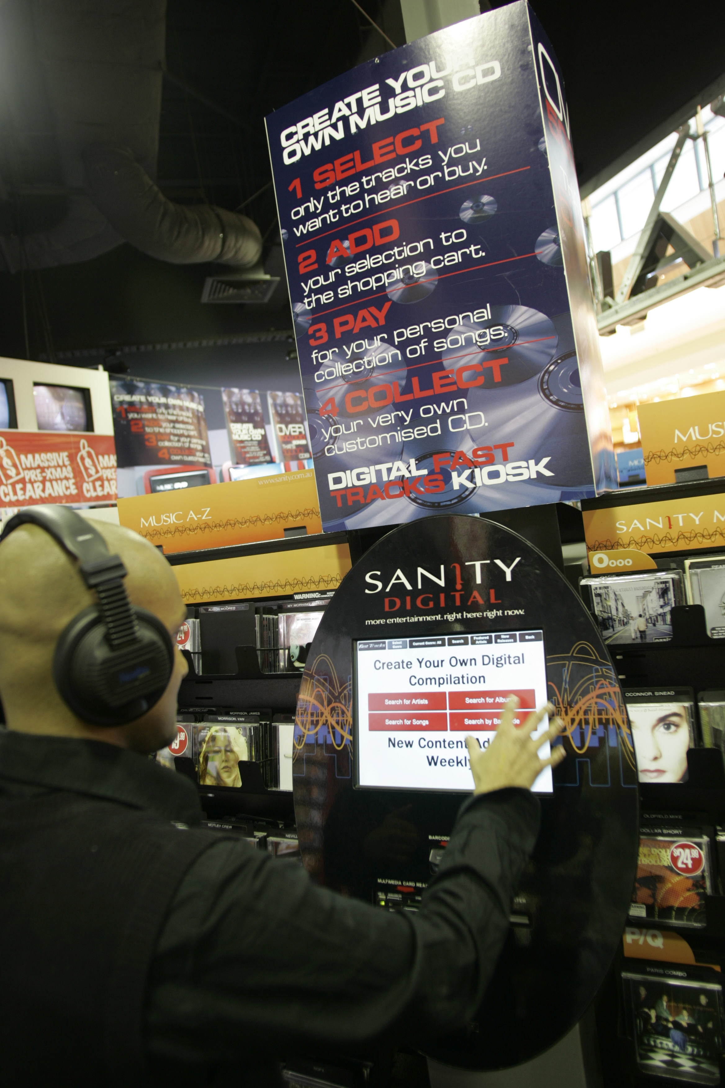 Blast from the past: A team member at Sanity scrolls through the menu of a 2006 digital kiosk where shoppers could once download over 50,000 CDs. 