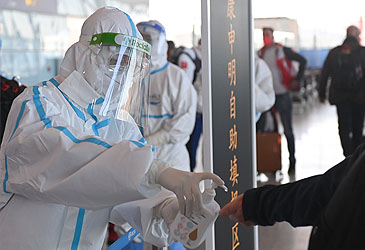 Official applying hand sanitiser at Beijing Capital International Airport (Getty)
