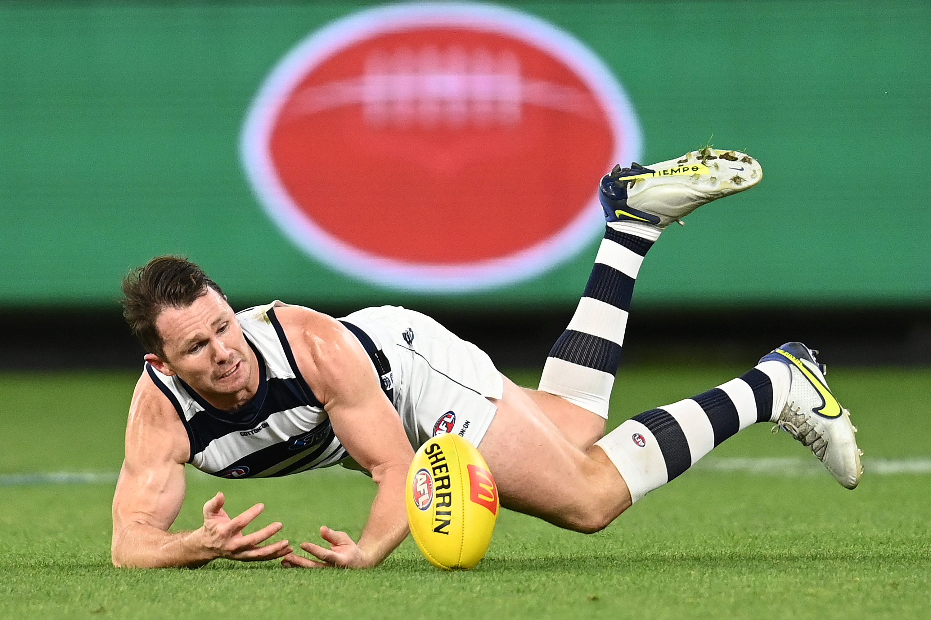 Patrick Dangerfield of the Cats dives for a mark.