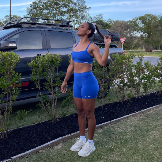 Courtney Hodder poses in blue activewear