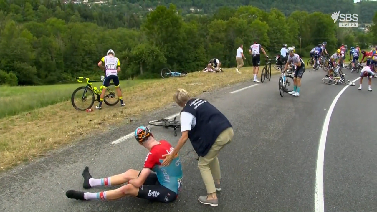 The start of the 14th stage of the Tour de France was marred by a massive pileup after a light shower slickened the road.
