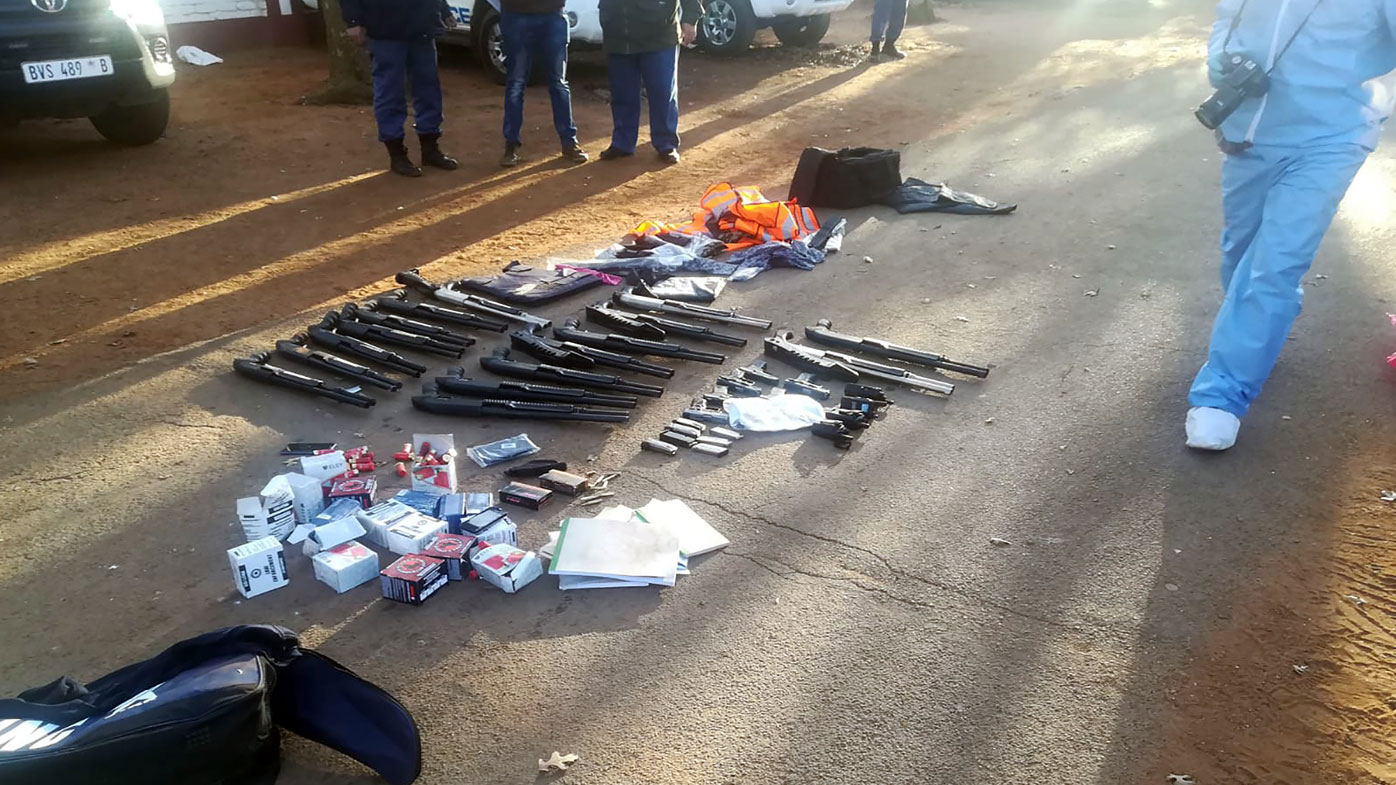 In this photo made available by the South African Police Services (SAPS), confiscated arms and ammunition, lay on the ground at a church in Zuurbekom, near Johannesburg, Saturday, July 11, 2020