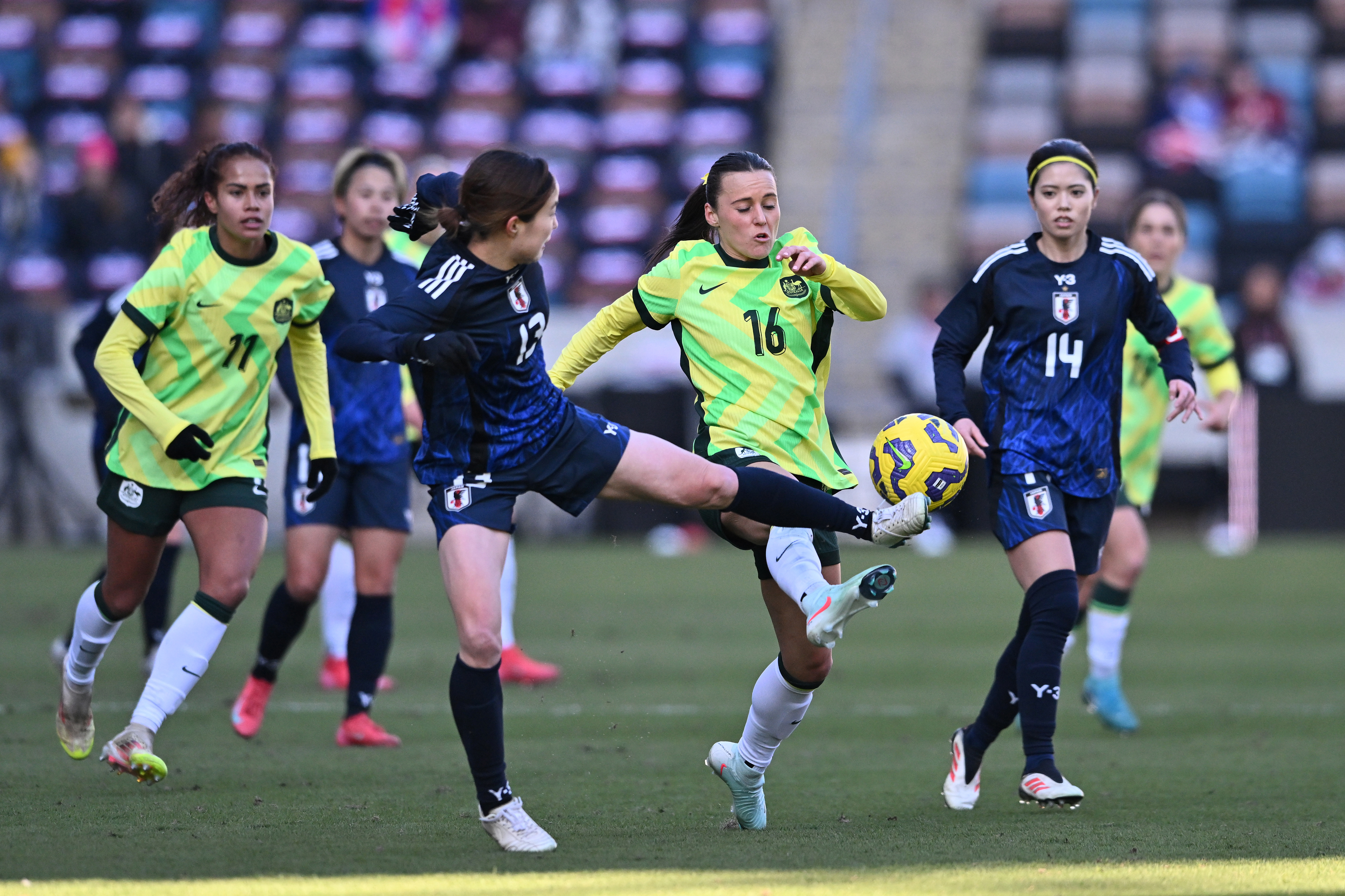 Hikaru Kitagawa of Japan and Hayley Raso of Australia battle for the ball.