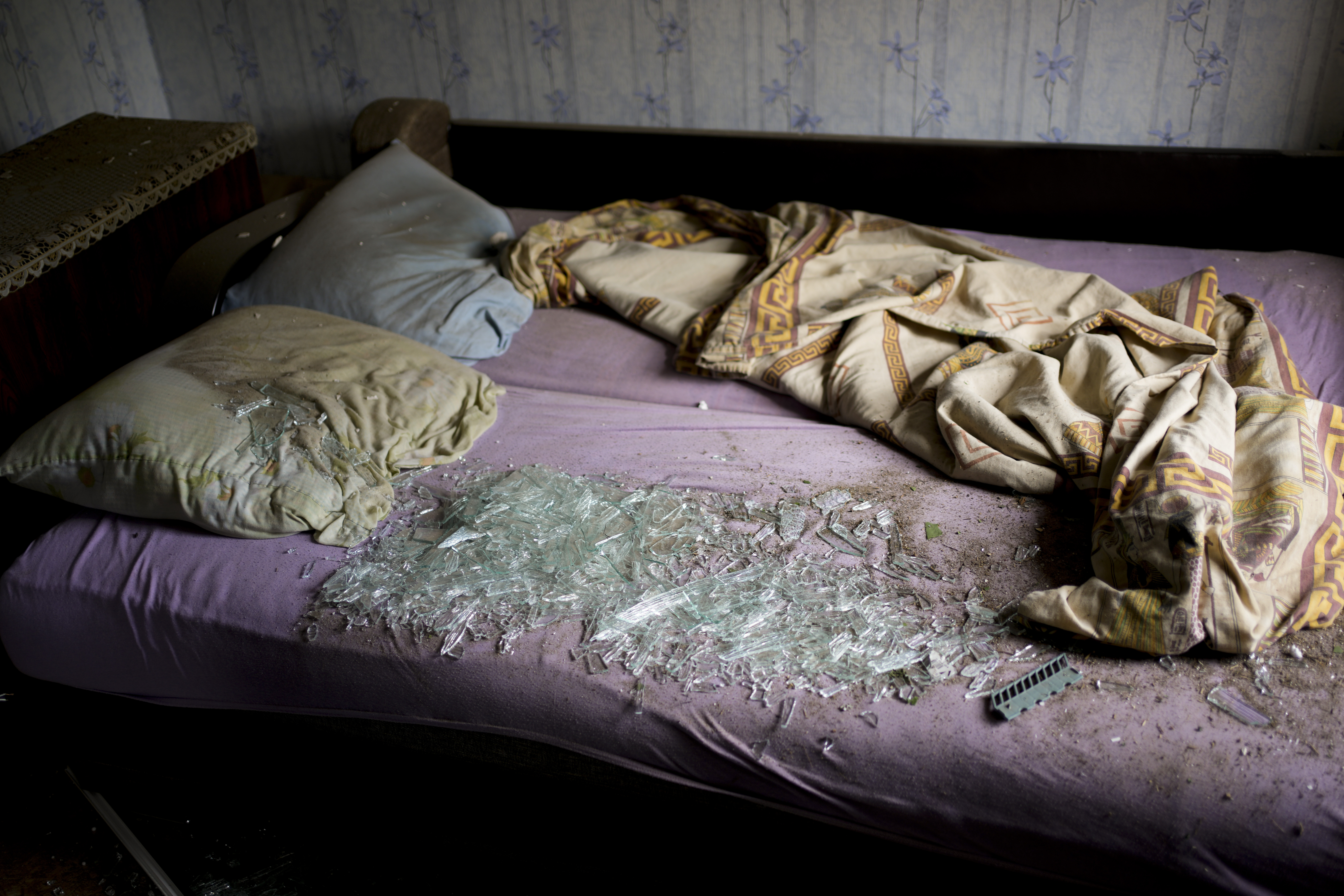 Shattered glass lies on the bed at a house damaged after a strike in Druzhkivka, Ukraine, Sunday, June 5, 2022. (AP Photo/Bernat Armangue)