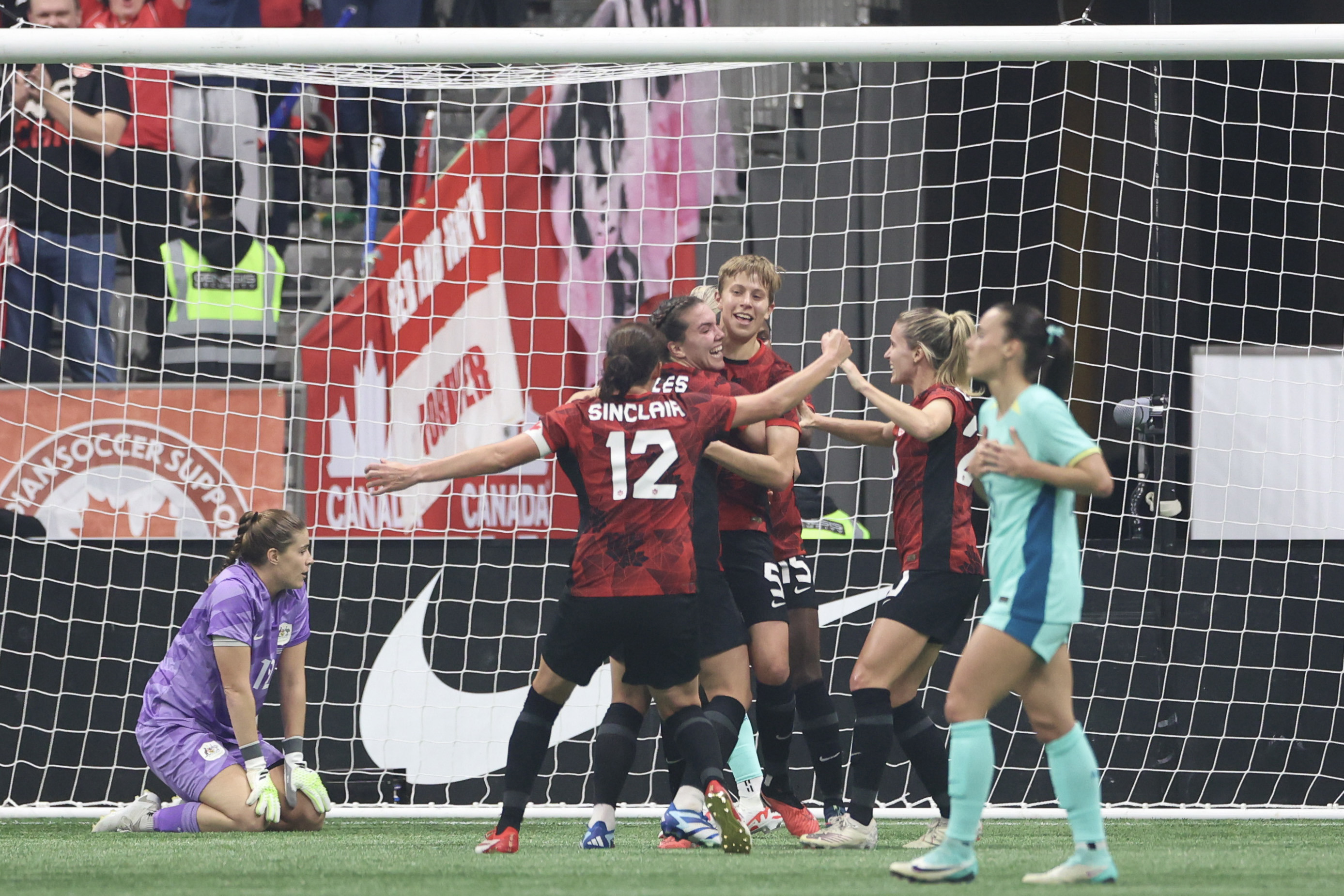 VANCOUVER, BRITISH COLUMBIA - DECEMBER 05: Quinn #5 of Canada reacts with teammates after scoring a goal during the first half against Australia at BC Place on December 05, 2023 in Vancouver, British Columbia. (Photo by Craig Mitchelldyer/Getty Images for Football Australia)