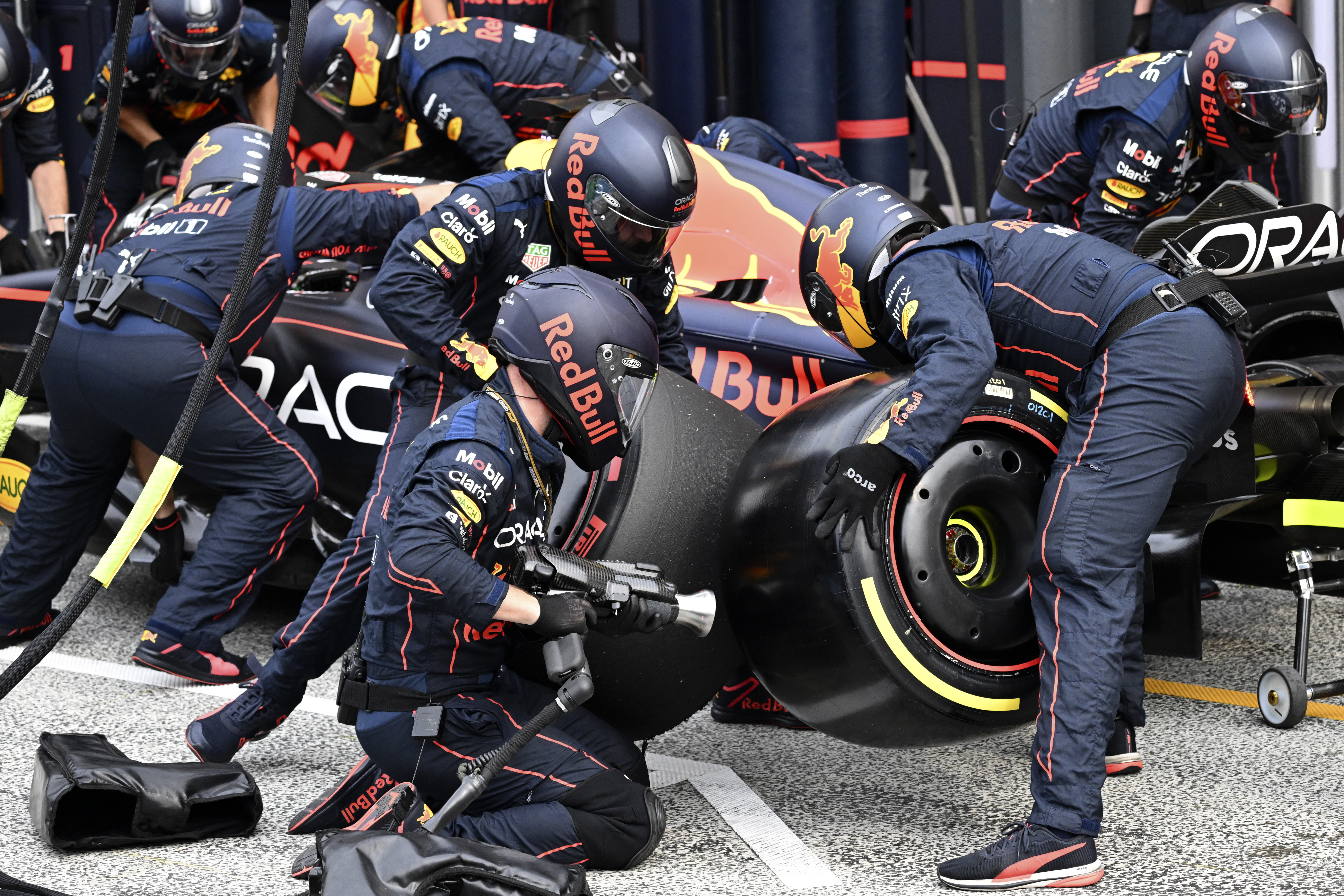 Red Bull mechanics work on the car of driver Max Verstappen of the Netherlands during the Formula One Dutch Grand Prix auto race, at the Zandvoort racetrack, in Zandvoort, Netherlands, Sunday, Sept. 4, 2022. (Christian Bruna/Pool via AP)