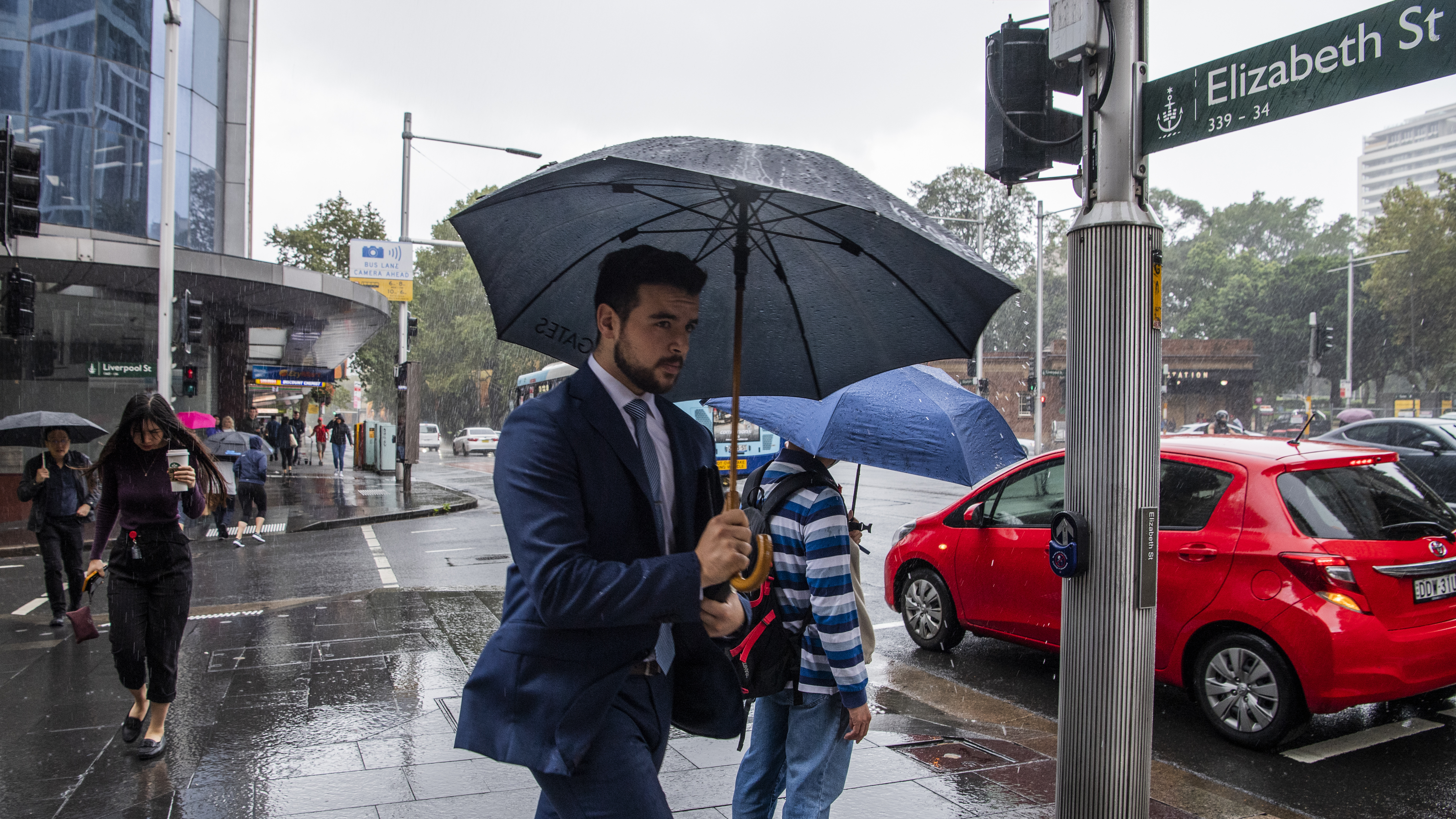 Workers tackle heavy rain in Sydney CBD, with more on the way.