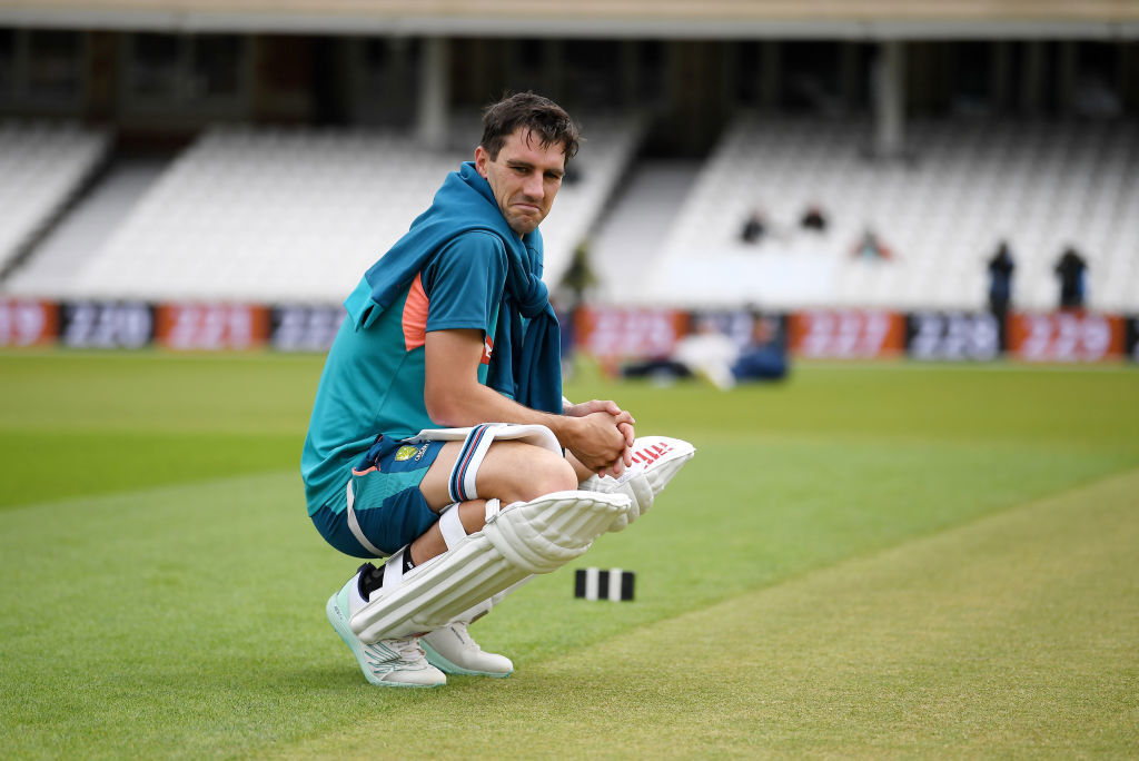 Pat Cummins of Australia inspects the pitch at The Oval.