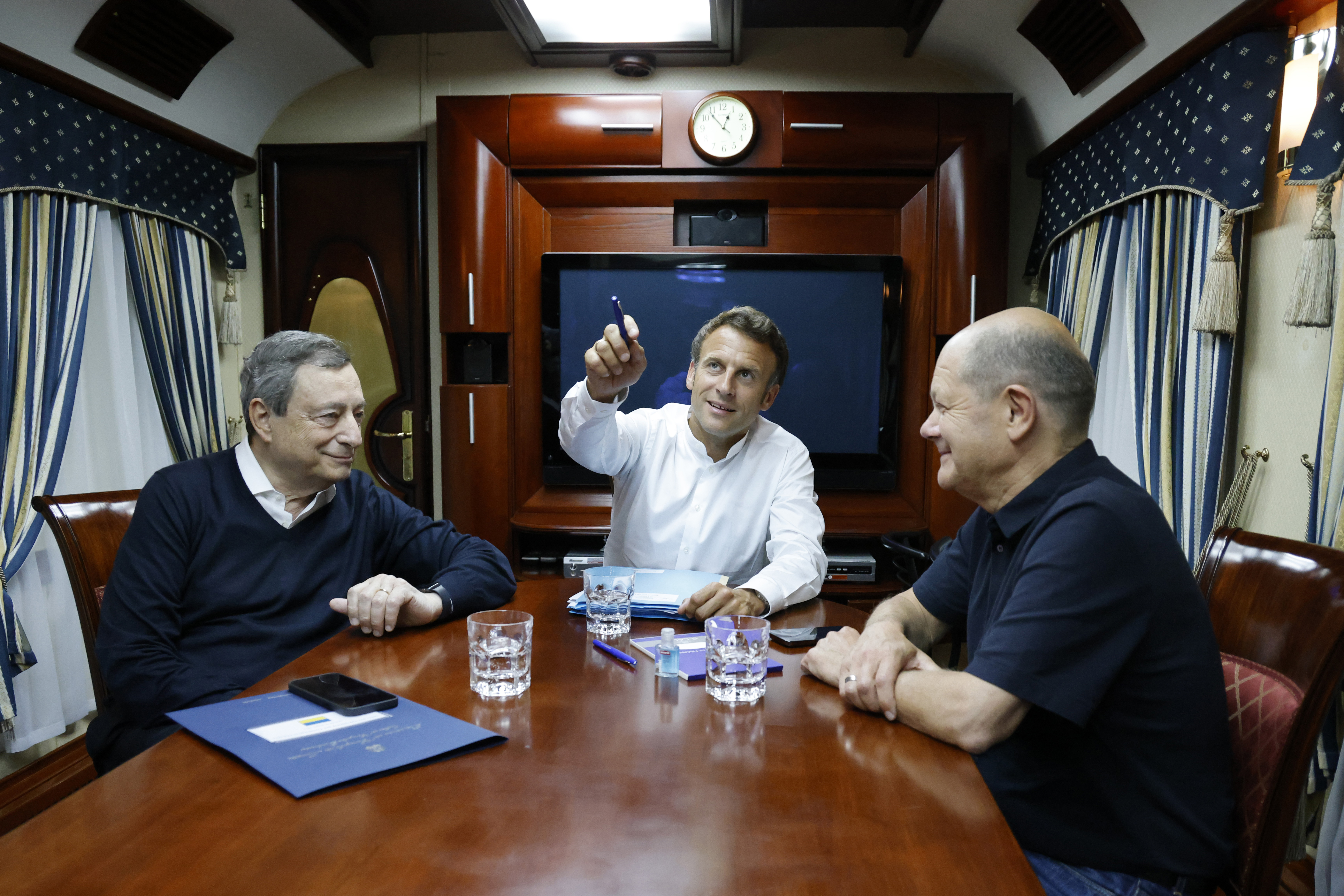 French President Emmanuel Macron, center, German Chancellor Olaf Scholz, right, and Italian Prime Minister Mario Draghi travel on board a train bound to Kyiv.