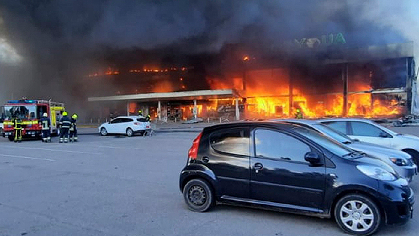 In this image made from video provided by Ukrainian State Emergency Service, firefighters work to extinguish a fire at a shopping center burned after a rocket attack in Kremenchuk, Ukraine, Monday, June 27, 2022. (Ukrainian State Emergency Service via AP)