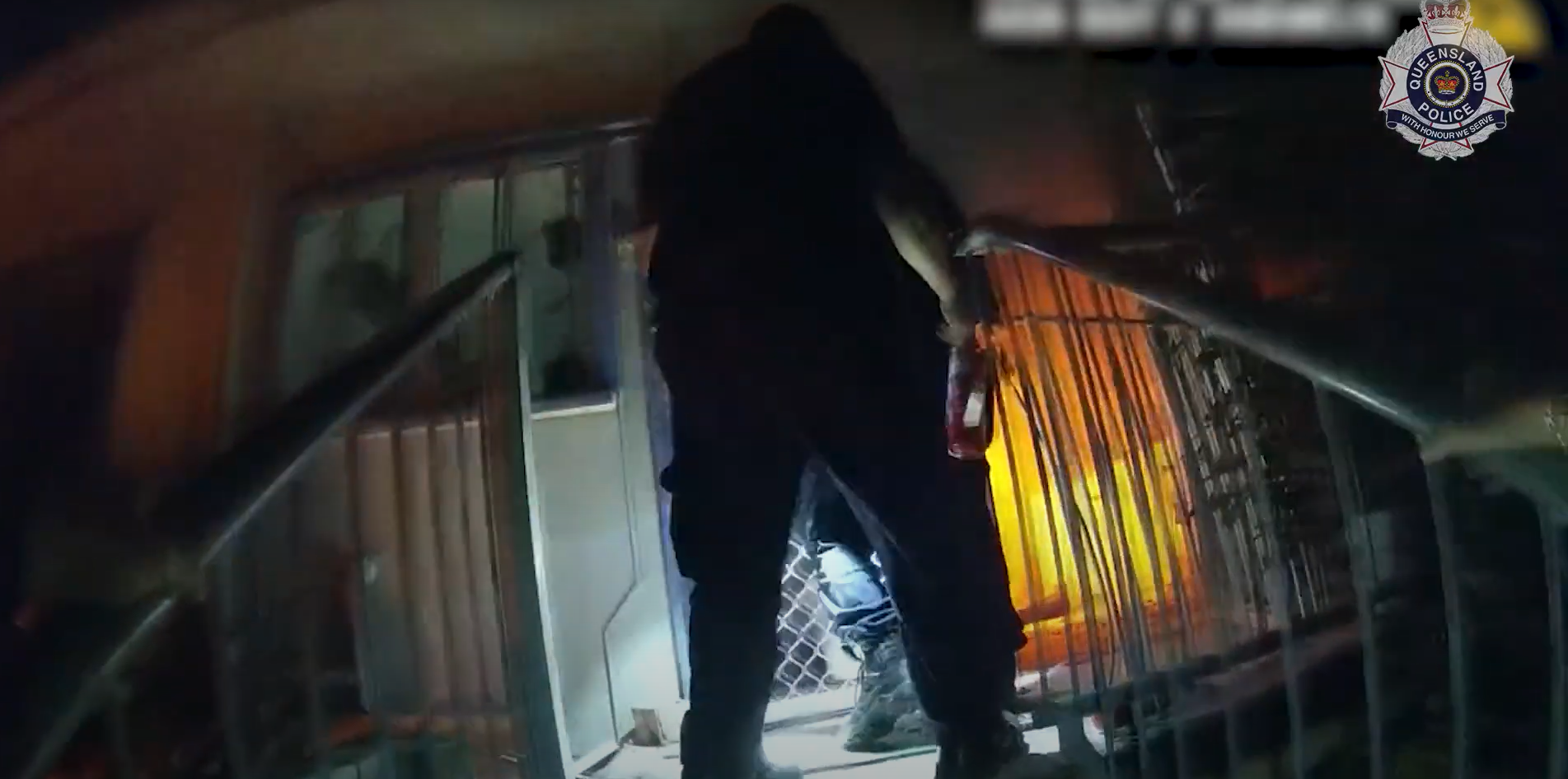 Dramatic vision has captured the moment police officers rescued an elderly couple, one of whom was in a wheelchair, and their grandson from flames that engulfed their home on the Gold Coast.