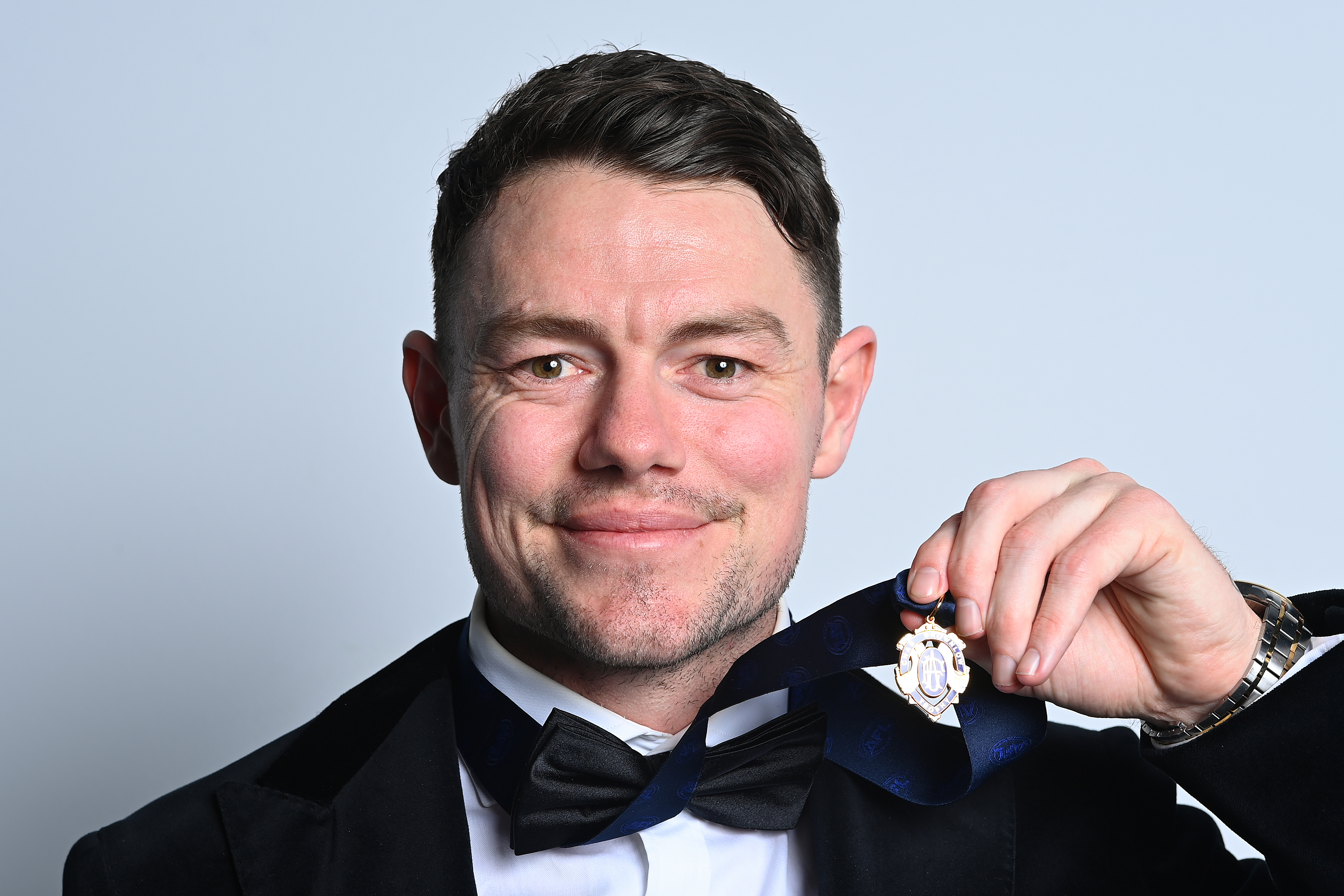 BRISBANE, AUSTRALIA - SEPTEMBER 25: Lachie Neale of the Lions poses for portraits with the Brownlow Medal during the 2023 Brownlow Medal at The Gabba on September 25, 2023 in Brisbane, Australia. (Photo by Albert Perez/AFL Photos via Getty Images)
