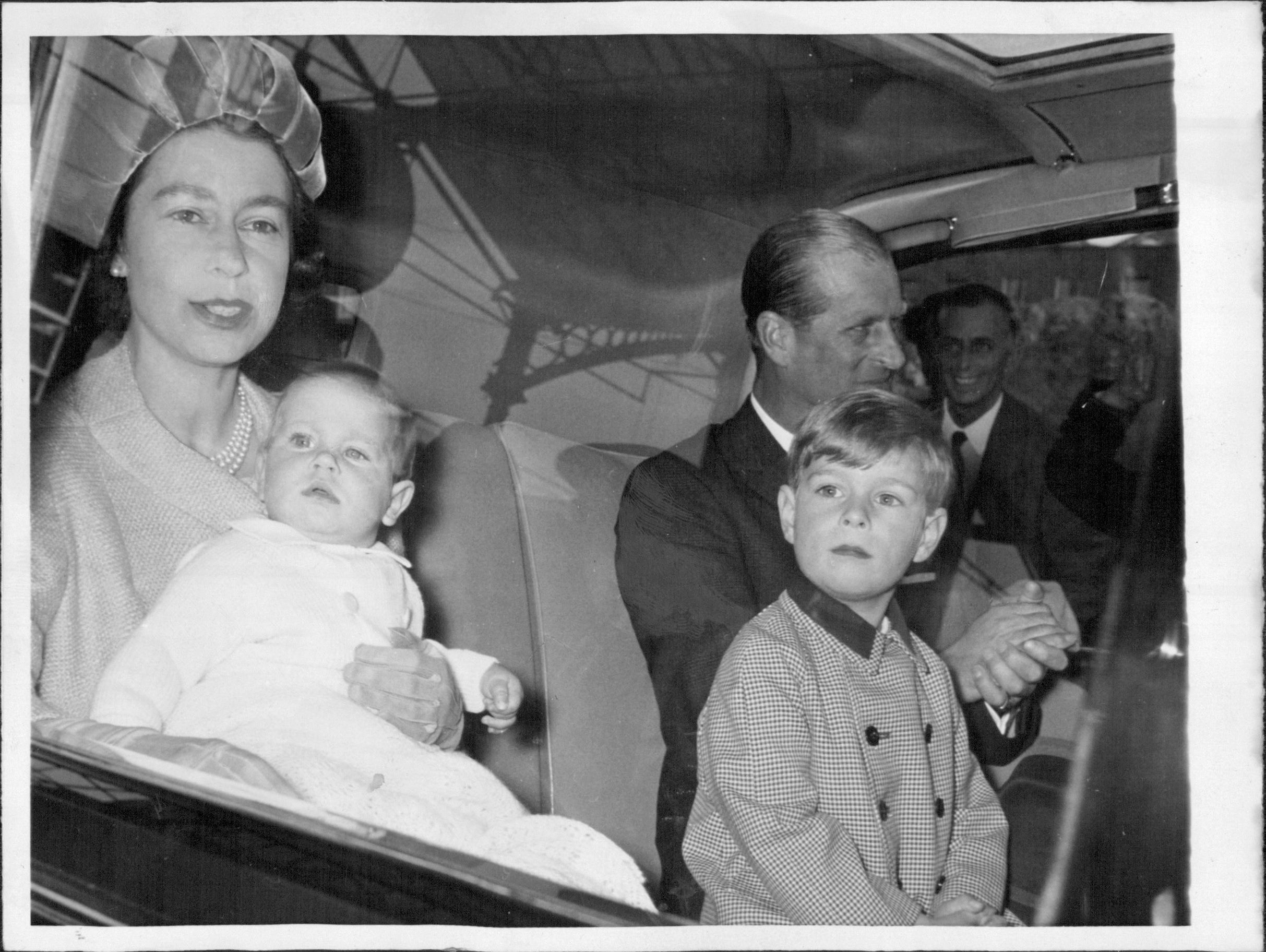Queen Returns from Balmoral. The Queen and the Duke of Edinburgh, with Prince Edward and Prince Andrew, their youngest children, leave Euston Station by car after arriving back in London from Balmoral today, October 2, at the end of their summer holiday in Scotland. The Queen and her husband leave for a tour of Canada in four days' time. Princes Edward and Andrew will be two of the Royal youngsters gathered at Sandringham with their parents this Christmas. In this photograph, taken in October, t