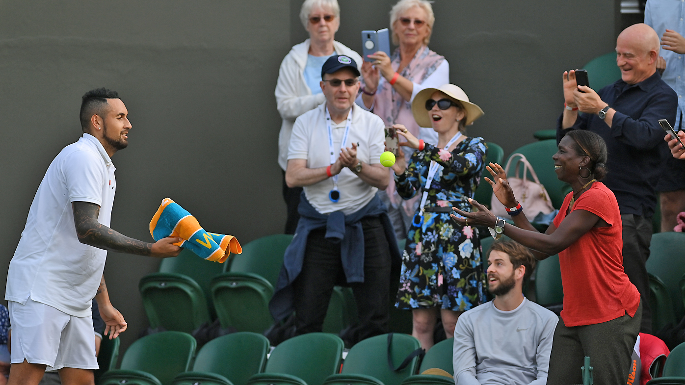 Nick Kyrgios hands a ball to a fan