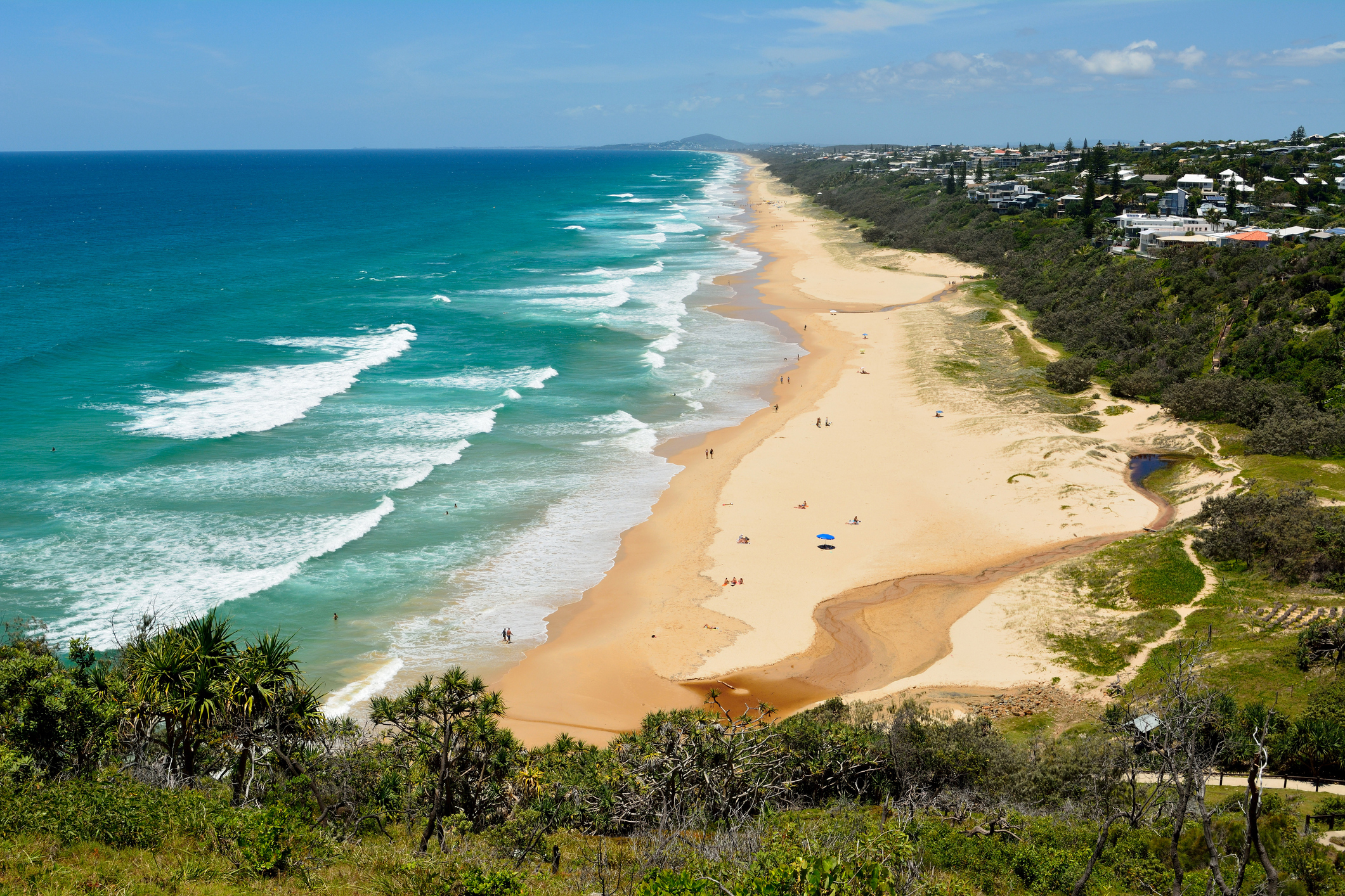 View over Sunshine Beach south of Noosa, QLD, with people.