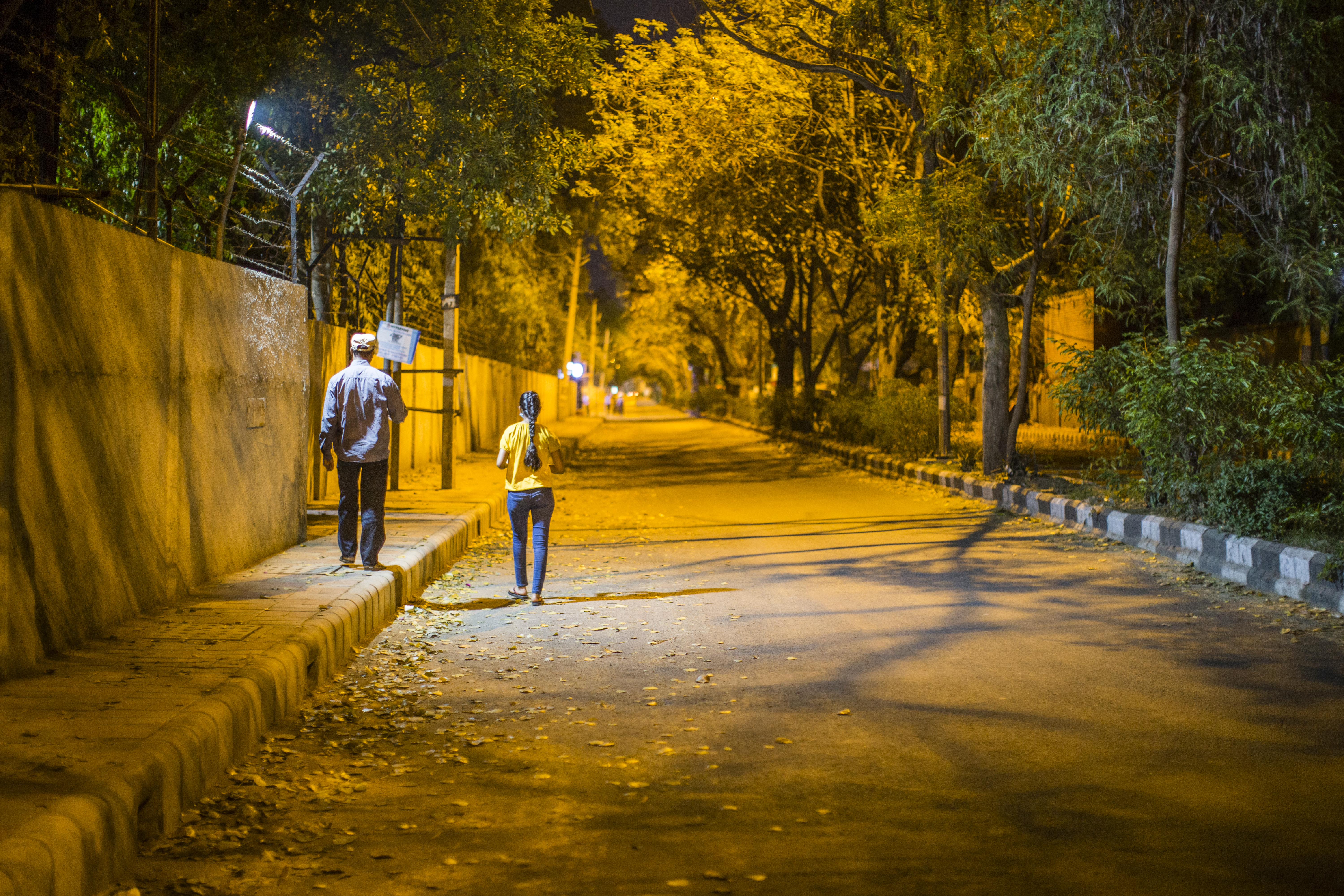 NEW DELHI, INDIA - MARCH 24: A man walks with his daughter on a deserted road, amid a nationwide lockdown over highly contagious novel coronavirus.