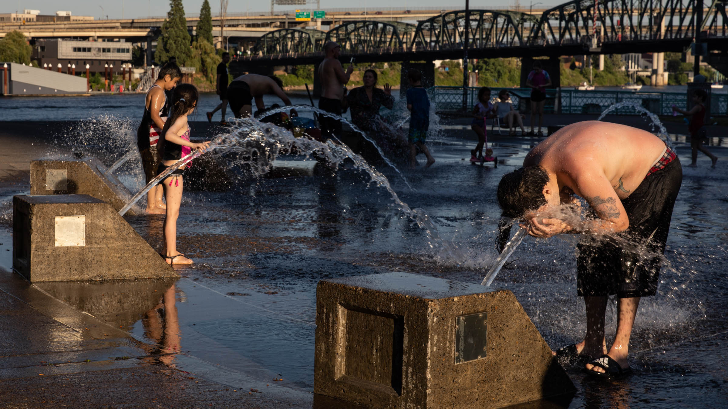 A boy cools off in a riverfront water fountain during a heatwave in Portland, Oregon, USA.