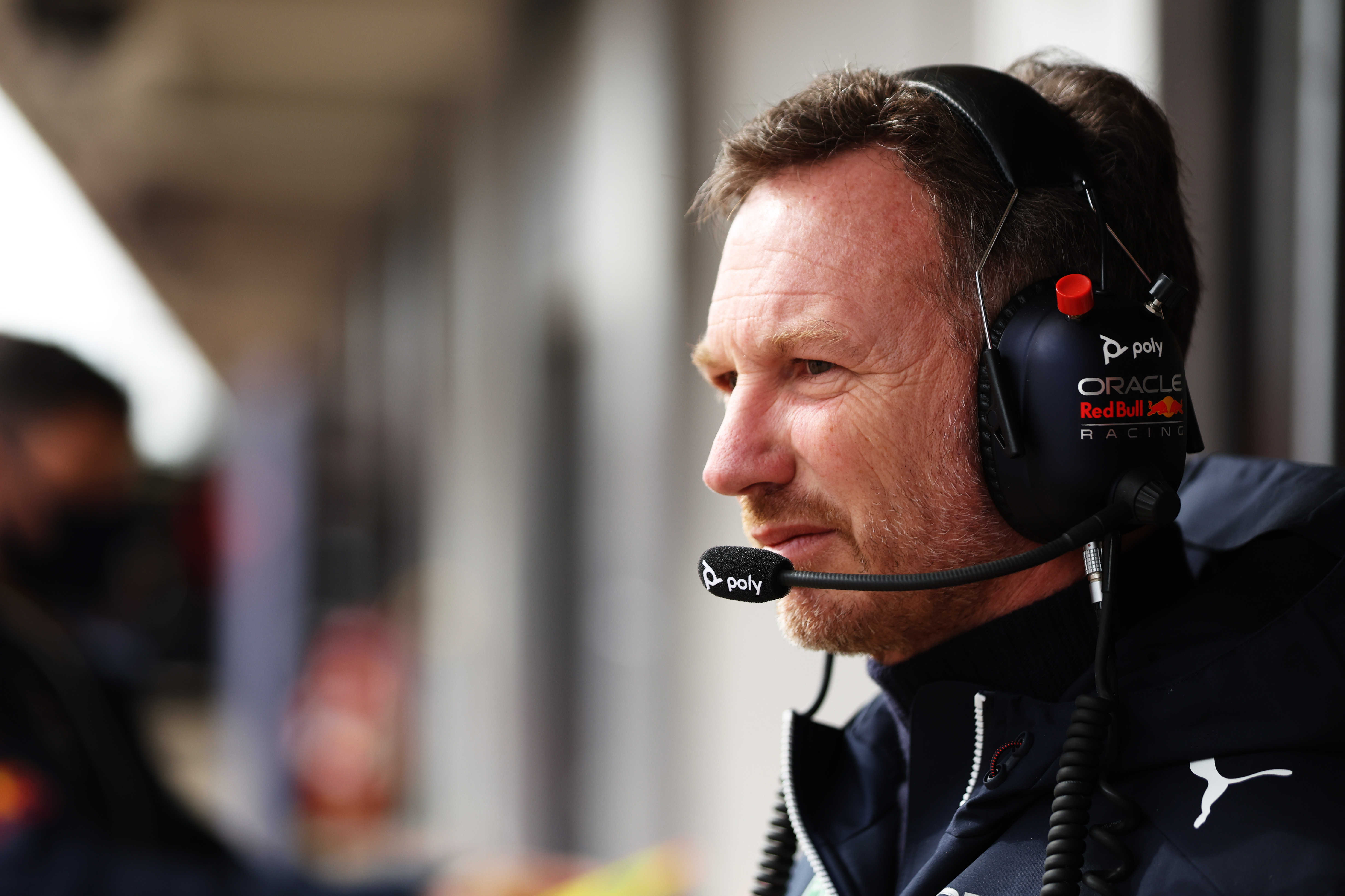 Red Bull Racing Team Principal Christian Horner looks on in the garage.
