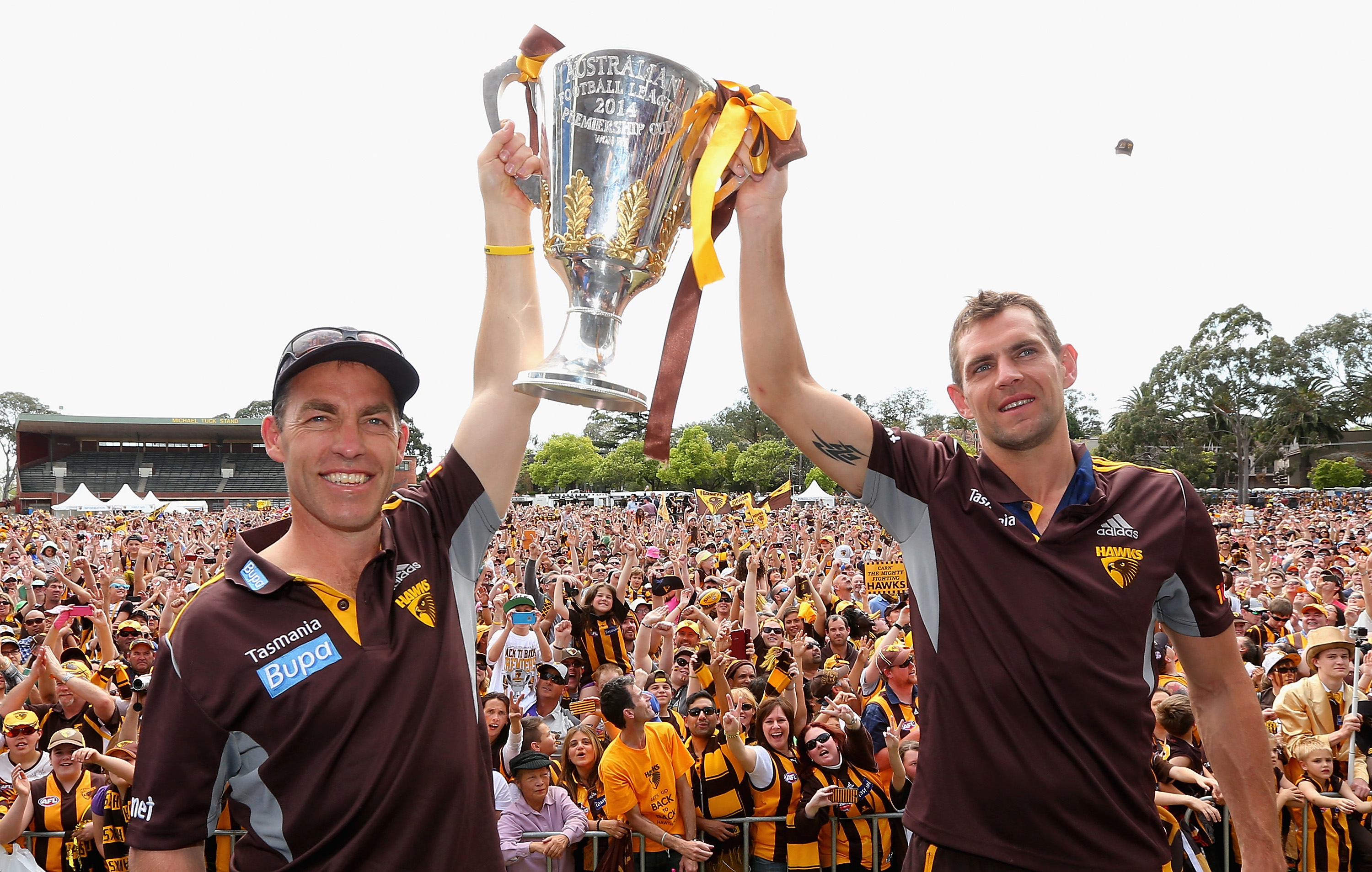Alastair Clarkson and Luke Hodge hold up the 2014 AFL premiership cup.