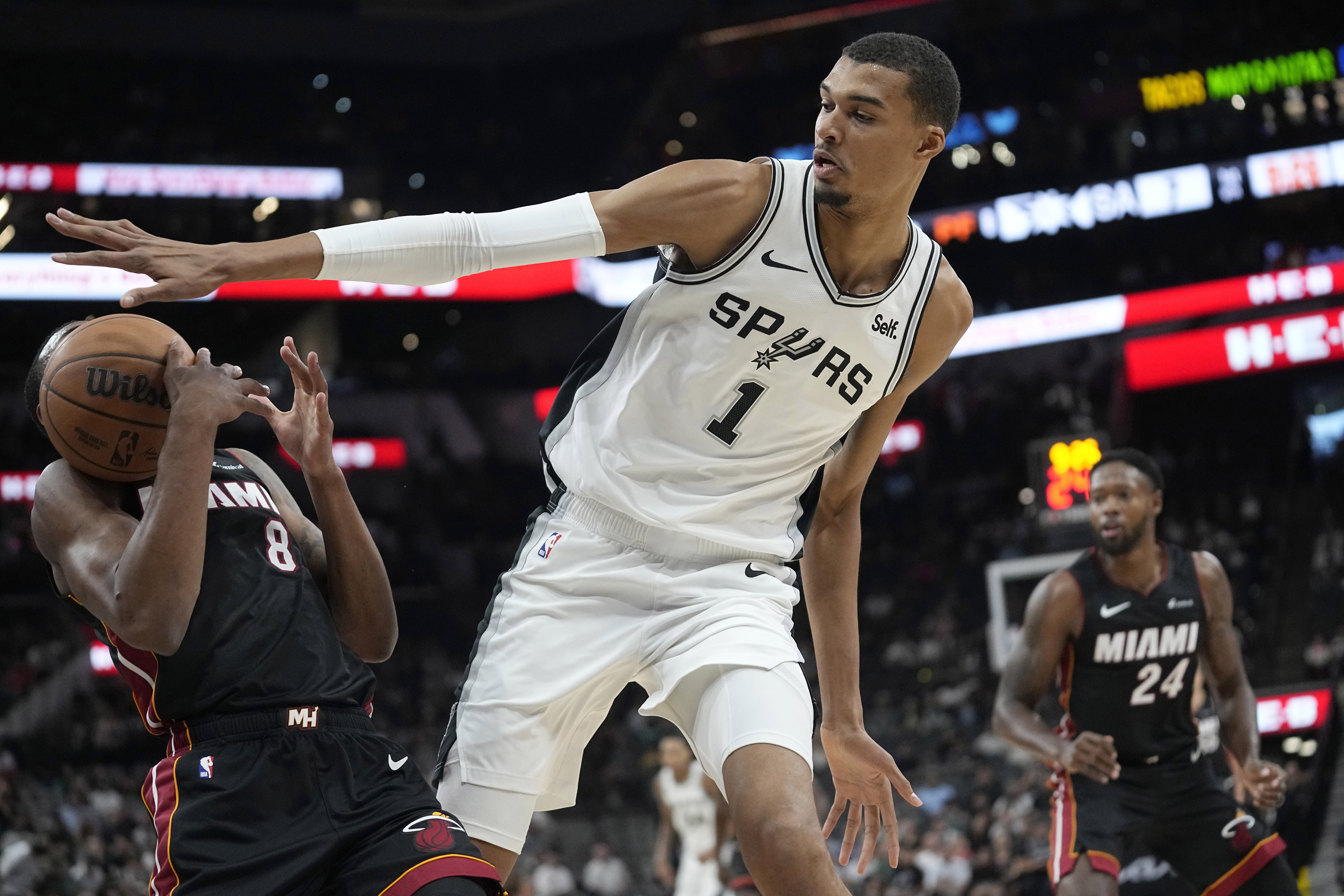 Miami Heat forward Jamal Cain (8) is blocked by San Antonio Spurs center Victor Wembanyama (1) during the first half of a preseason NBA basketball game in San Antonio, Friday, Oct. 13, 2023. (AP Photo/Eric Gay)