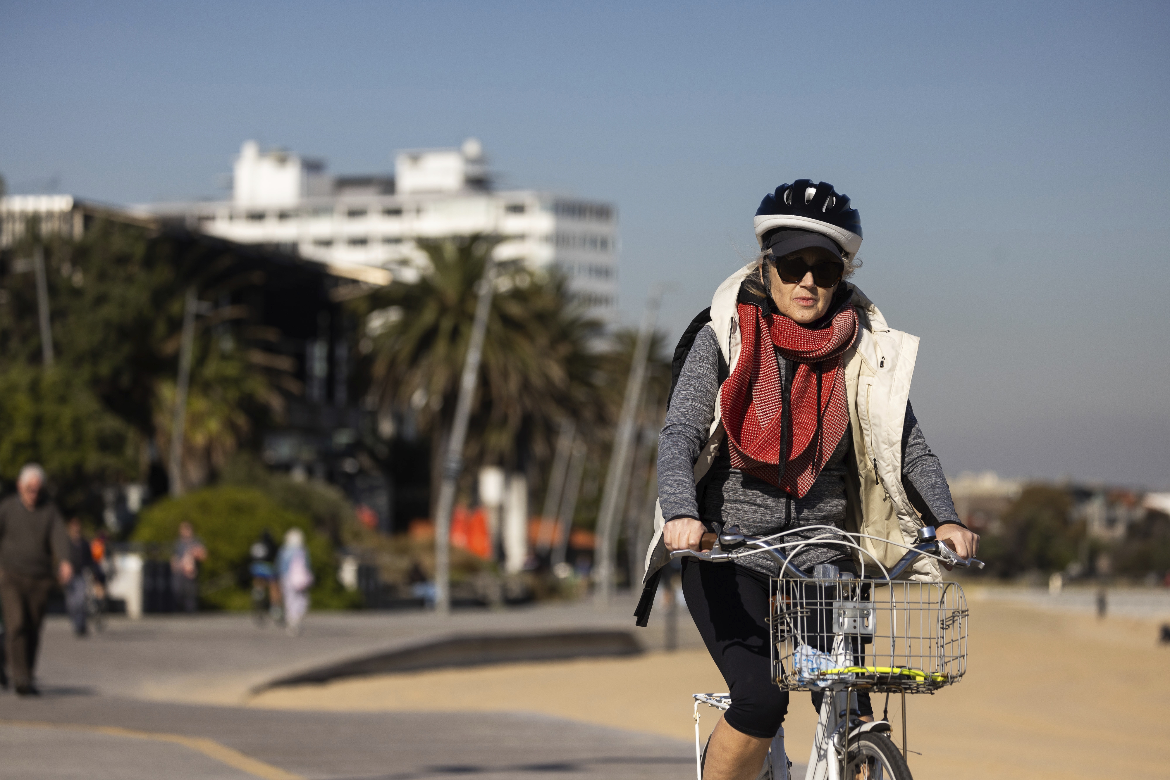 A bike rider on St Kilda beach.