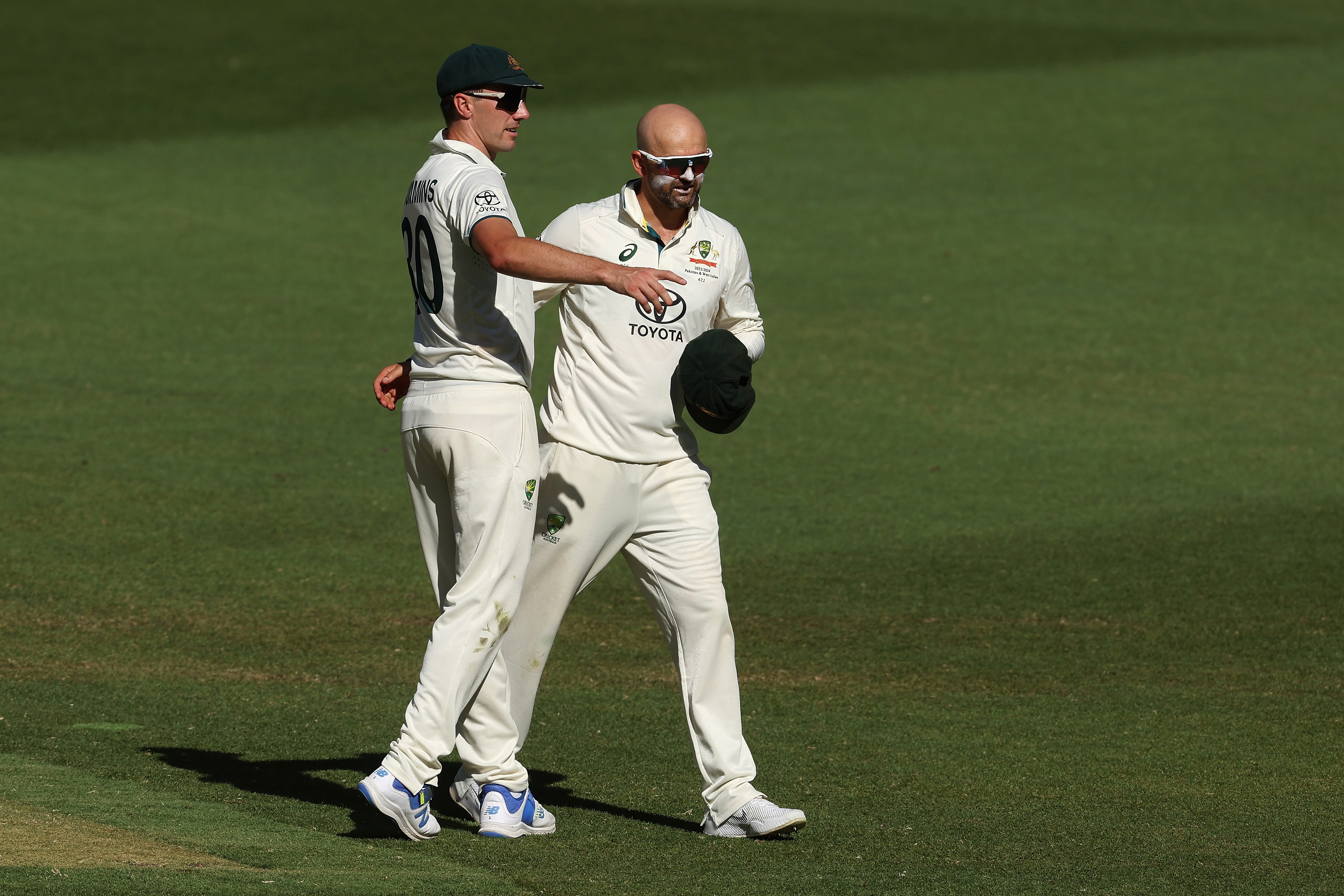 PERTH, AUSTRALIA - DECEMBER 17: Nathan Lyon of Australia celebrates with Australian captain Pat Cummins after dismissing Faheem Ashraf of Pakistan following a DRS review and taking his 500th test wicket during day four of the Men's First Test match between Australia and Pakistan at Optus Stadium on December 17, 2023 in Perth, Australia (Photo by Paul Kane/Getty Images)