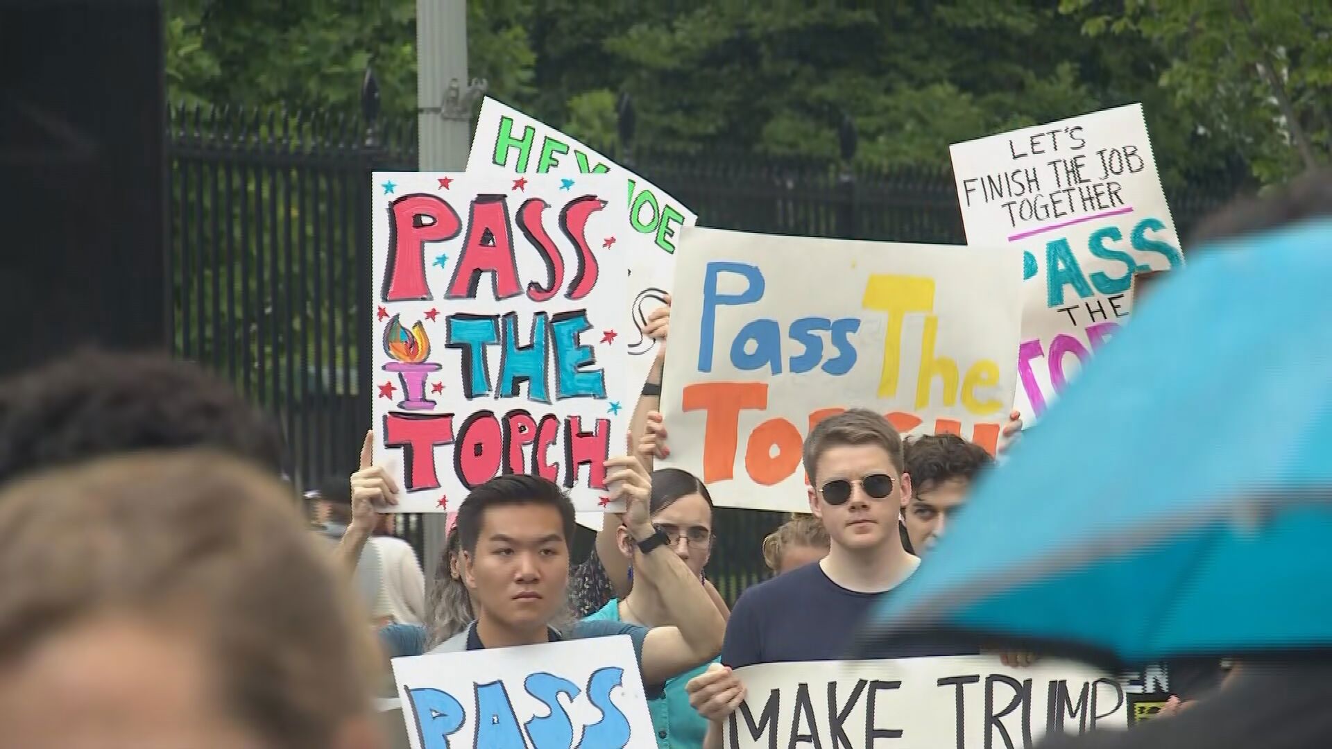 Protesters gather at the White House on Saturday calling on President Biden to "pass the torch"