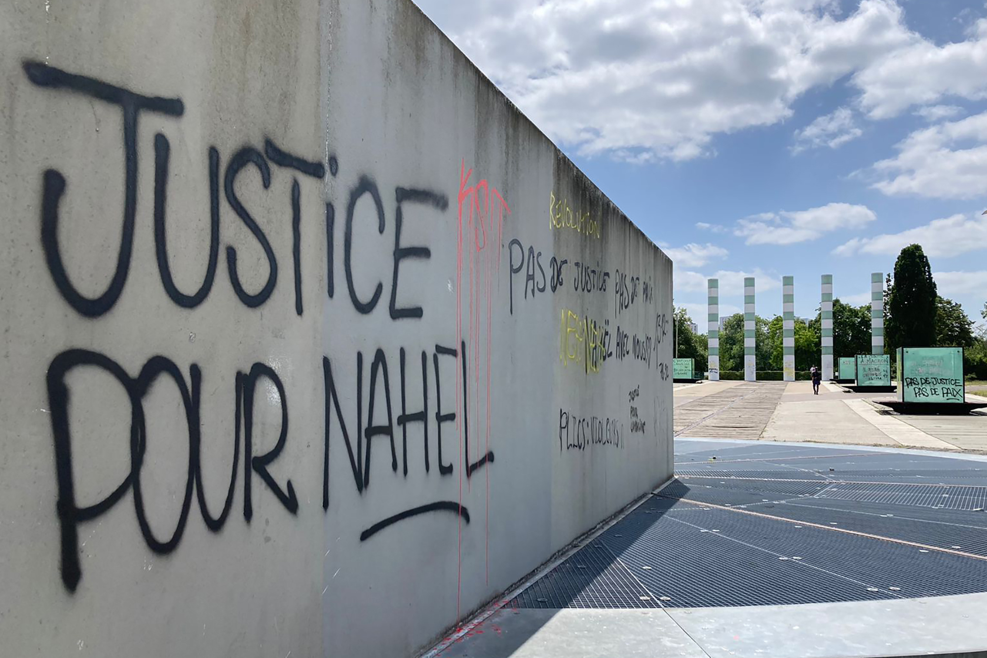 A graffiti reads "Justice for Nahel" on a wall Sunday, July 2, 2023 in Paris suburb Nanterre. A monument commemorating Holocaust victims and members of the French resistance during World War II in Nanterre was still defaced with graffiti Sunday, after it has been vandalized Thursday on the margins of a silent march to pay tribute to Nahel. Vandals painted anti-police slogans including "Police scum from Saint-Soline to Nanterre," "Don't forget or forgive," and "Police, rapists, assassins".